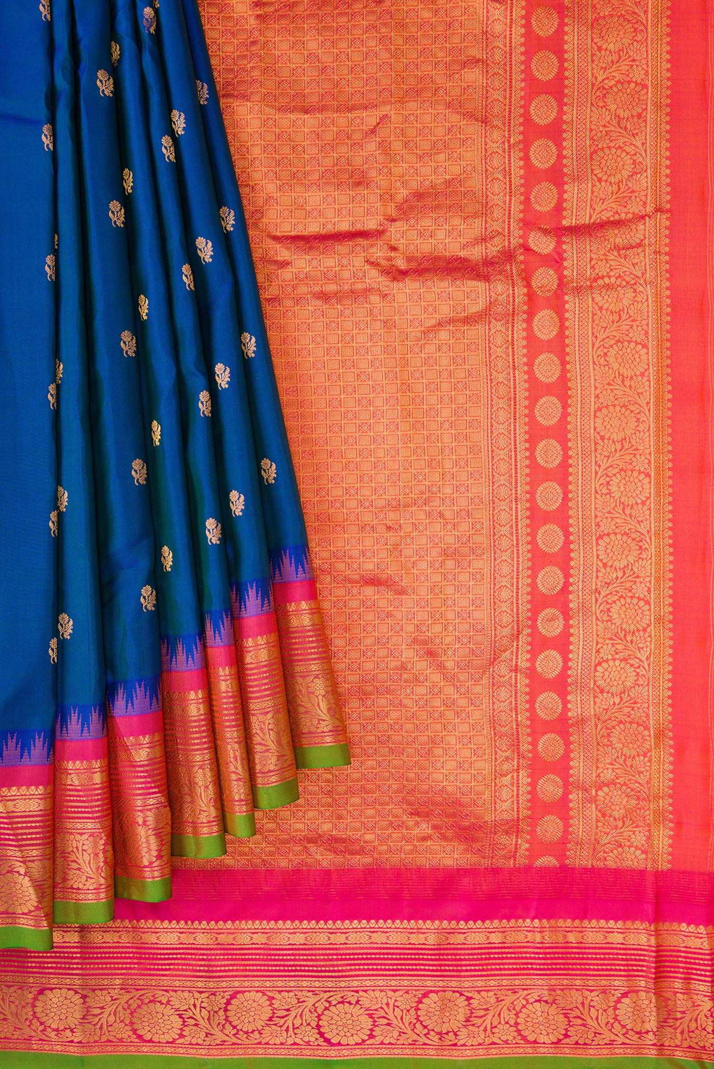 Pleats and pallu of Peacock Blue Dual Tone Gadwal Silk Saree with Zari Butta on the body and Temple Border. 