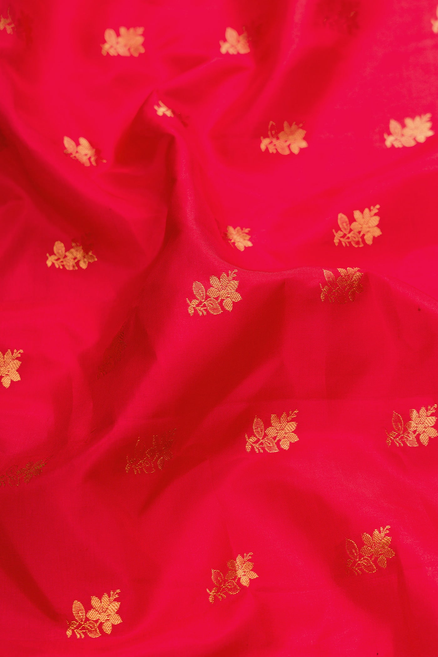 Close up of Red Dual Tone Gadwal Silk Saree with Zari Butta on the body and Zari Border.  displaying folds