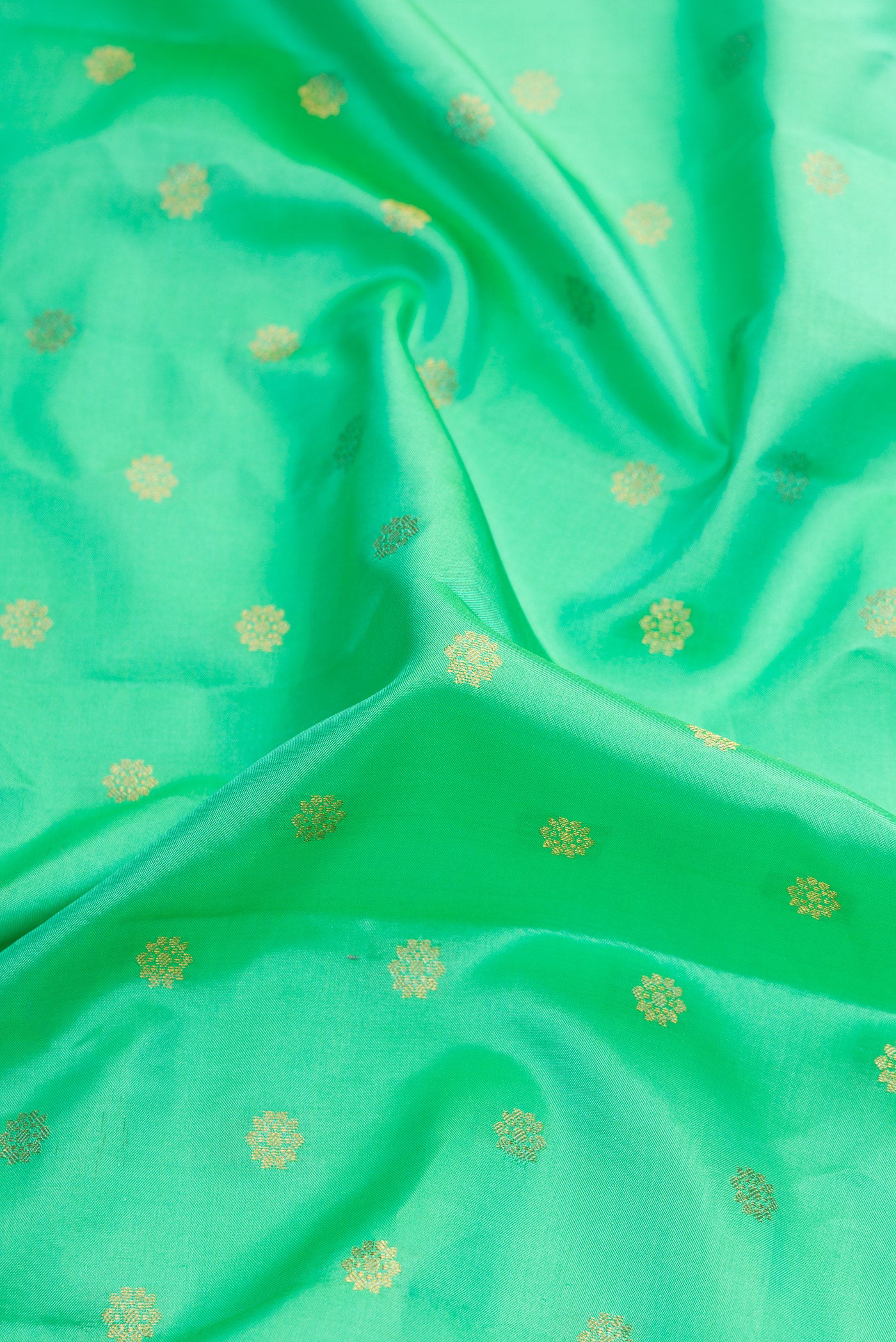 Close up of Sea Green Dual Tone Gadwal Silk Saree with Zari Butta on the body and Zari Border.  displaying folds