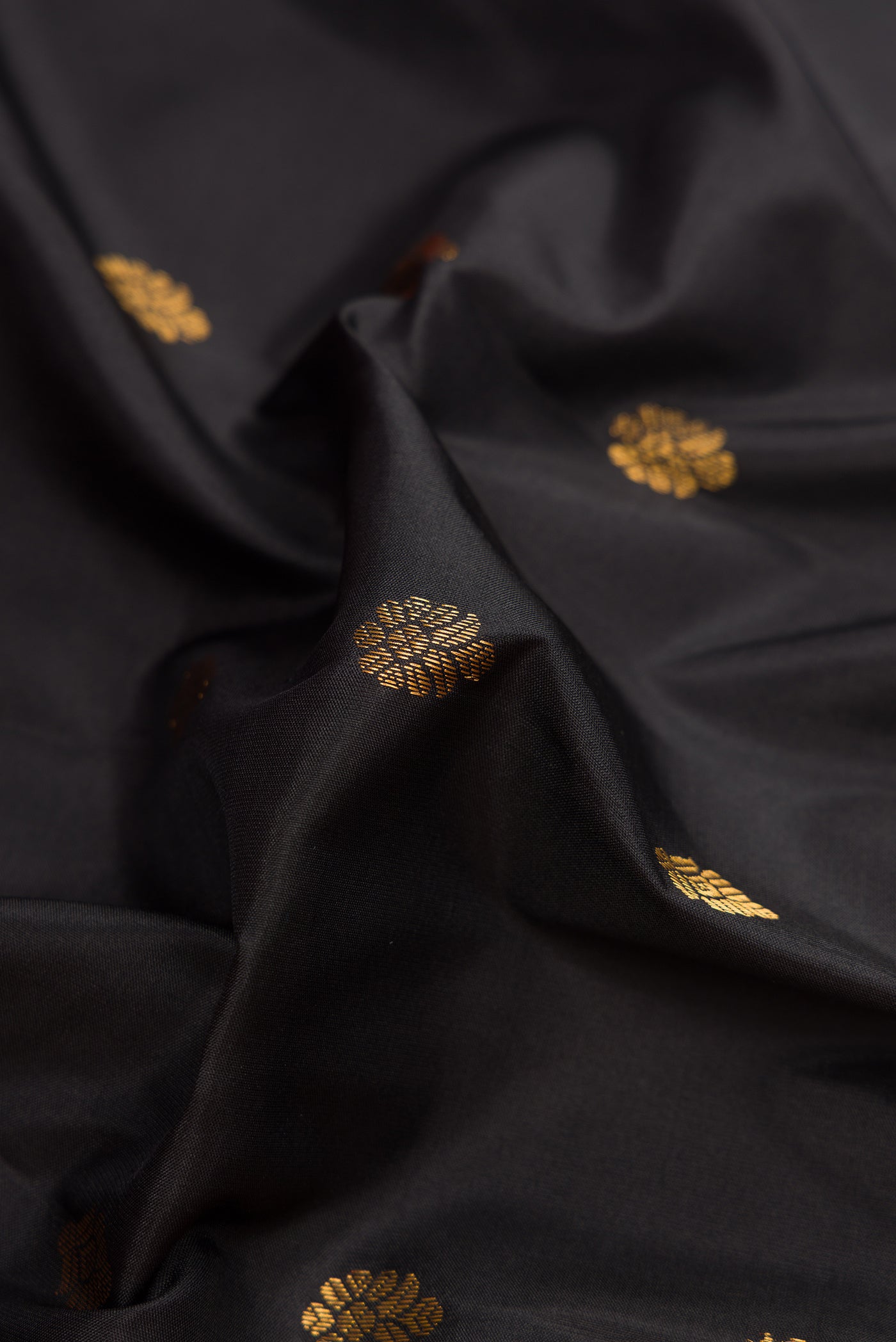 Close up of Black Dual Tone Gadwal Silk Saree with Zari Butta on the body and Zari Border.  displaying folds