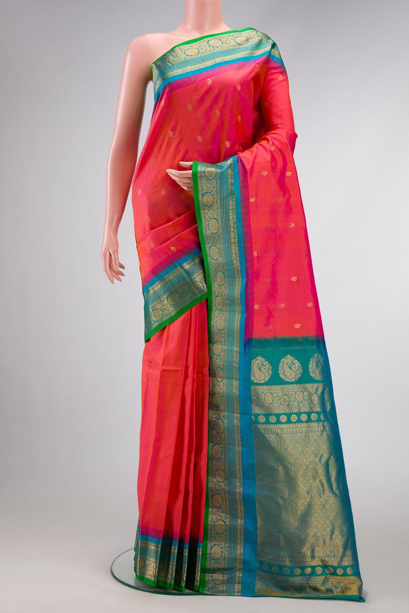 Coral Dual Tone Gadwal Silk Saree with Zari Butta on the body and Zari Border.  displayed on a mannequin