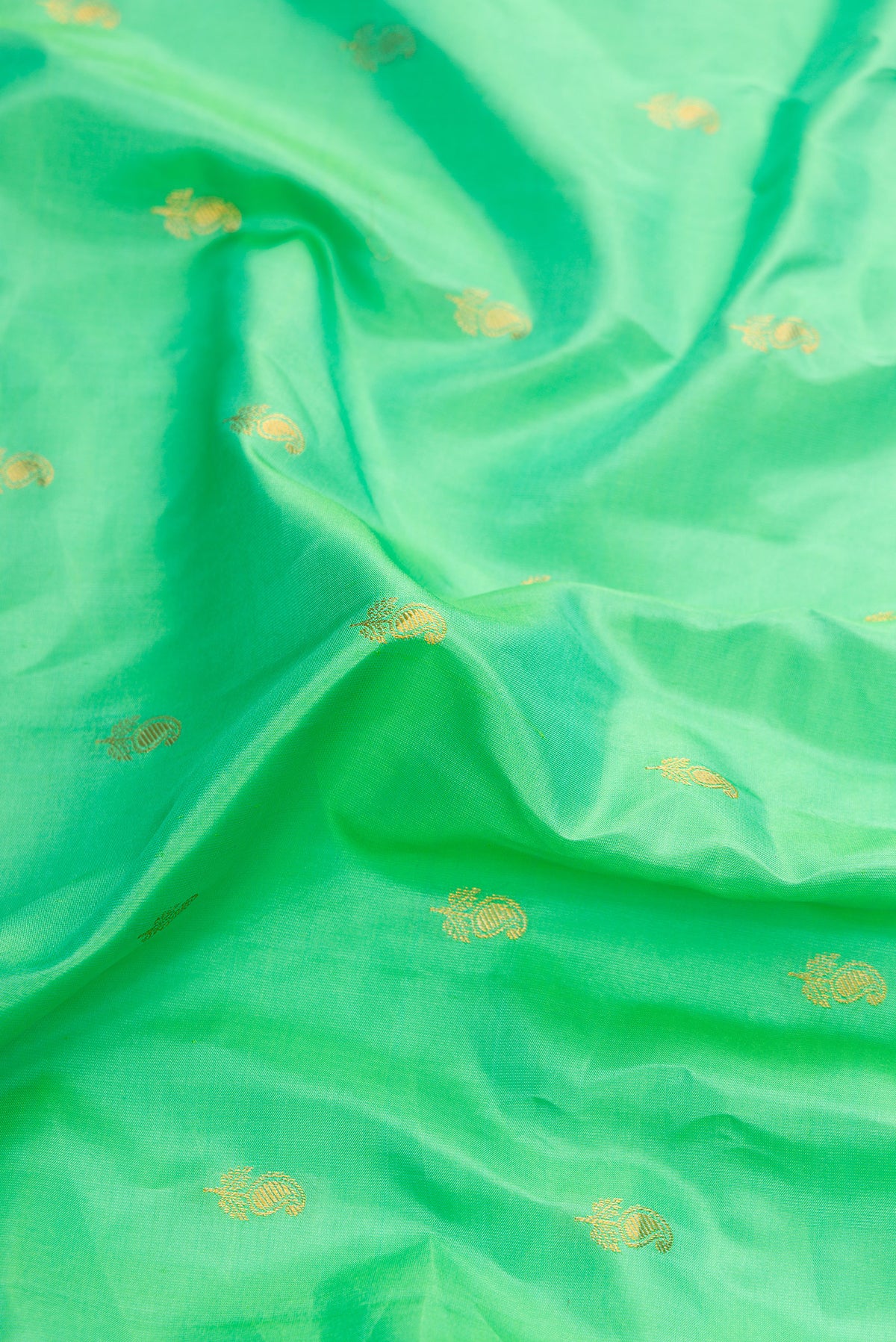 Close up of Sea Green Dual Tone Gadwal Silk Saree with Zari Butta on the body and Zari Border.  displaying folds