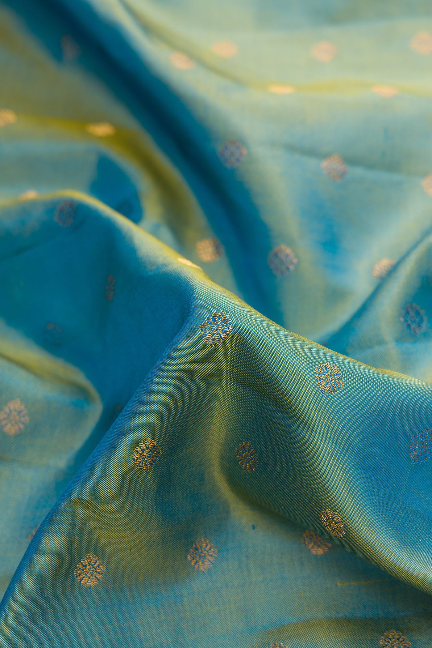 Close up of Light Green Dual Tone Gadwal Silk Saree with Zari Butta on the body and Zari Border.  displaying folds