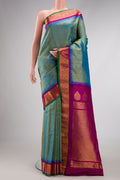 Light Green Dual Tone Gadwal Silk Saree with Zari Butta on the body and Zari Border.  displayed on a mannequin