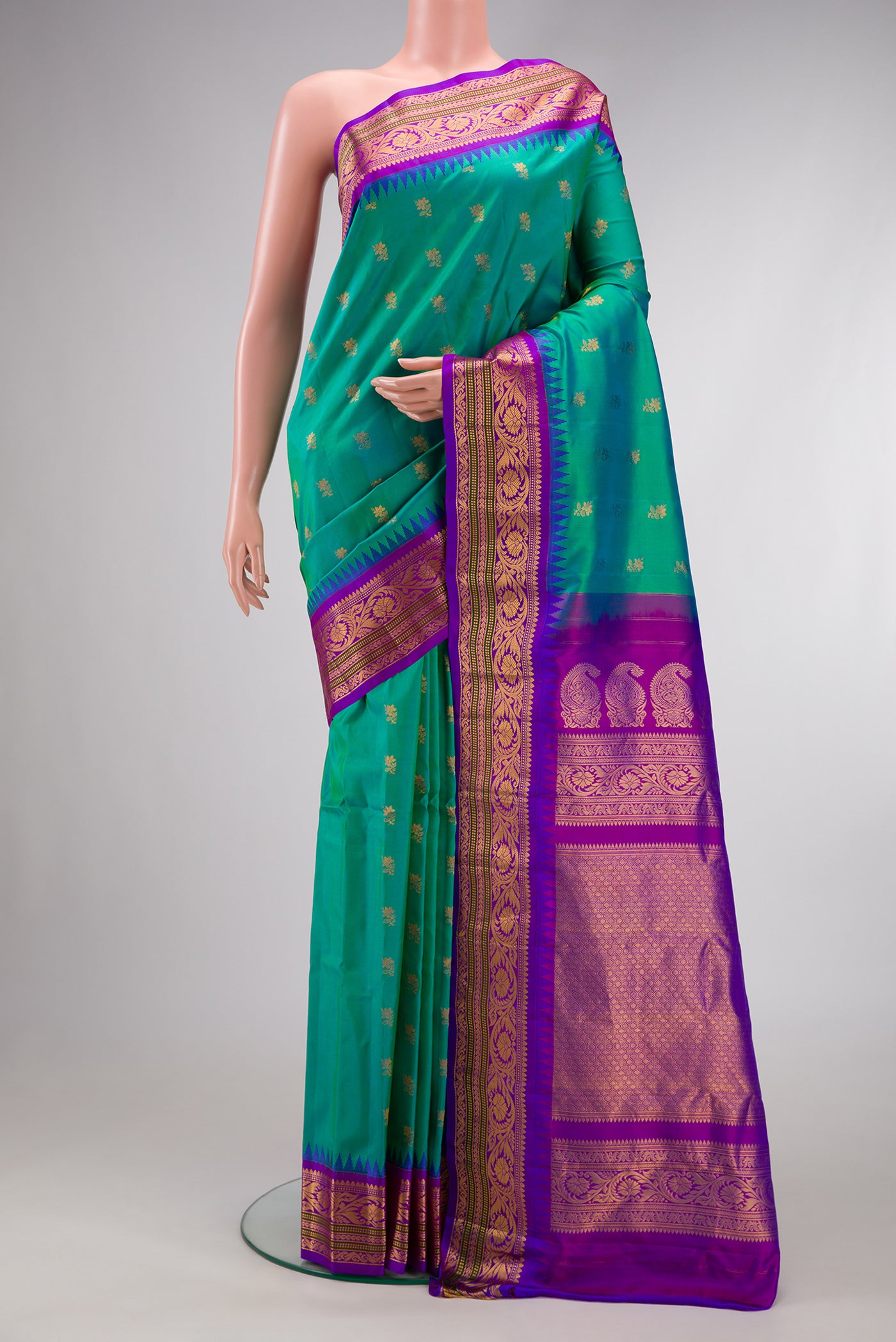 Sea Green Dual Tone Gadwal Silk Saree with Zari Butta on the body and Zari Border.  displayed on a mannequin