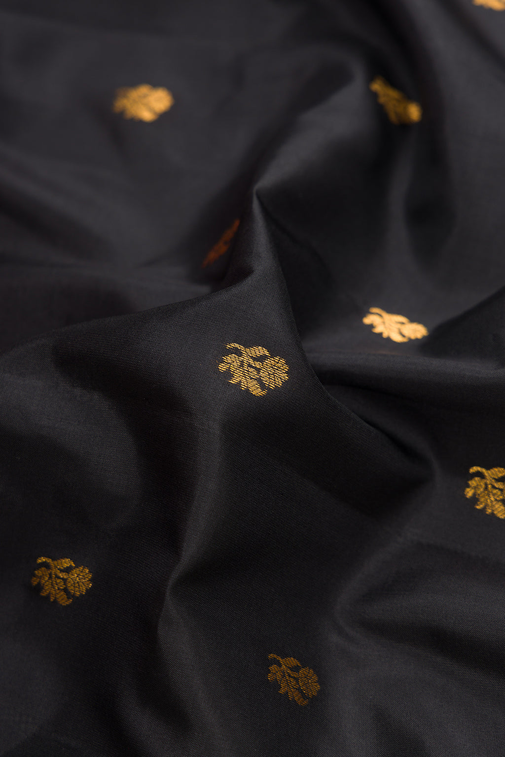 Close up of Black Dual Tone Gadwal Silk Saree with Zari Butta on the body and Zari Border.  displaying folds