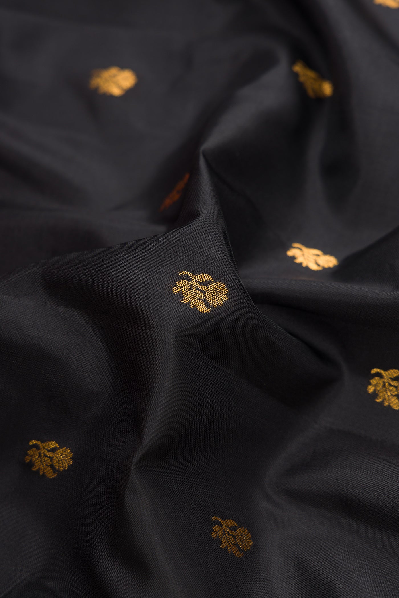 Close up of Black Dual Tone Gadwal Silk Saree with Zari Butta on the body and Zari Border.  displaying folds