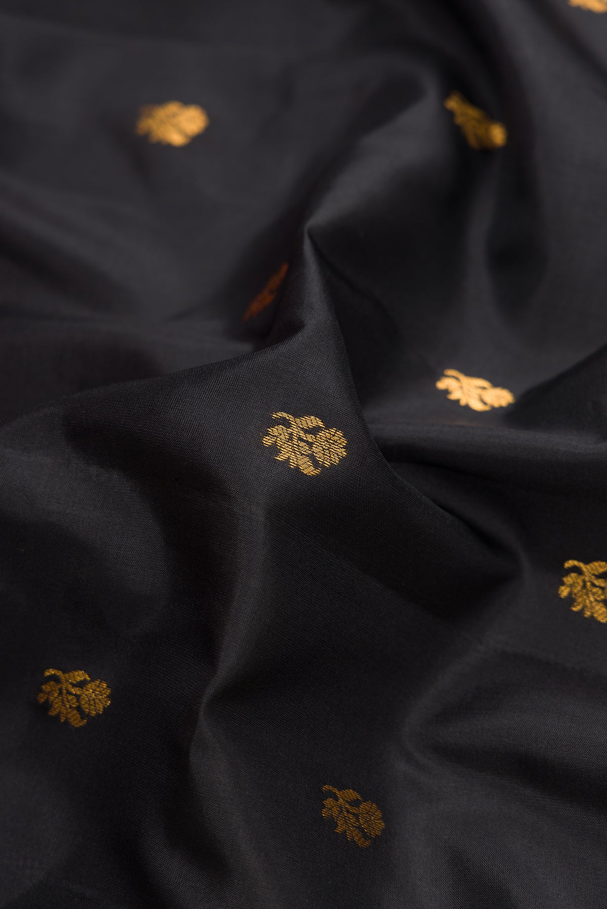 Close up of Black Dual Tone Gadwal Silk Saree with Zari Butta on the body and Zari Border.  displaying folds