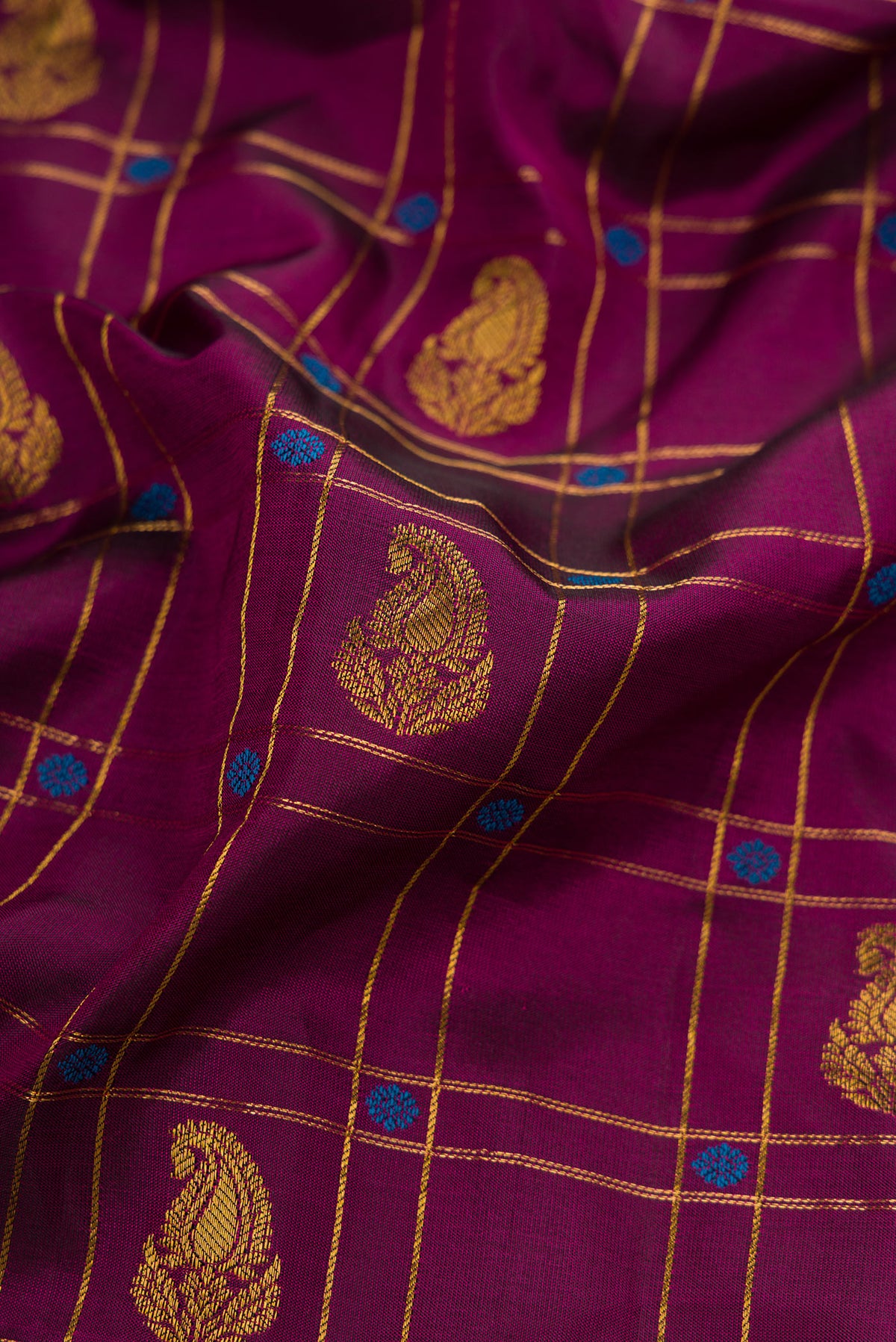 Close up of Burgundy Dual Tone Gadwal Silk Saree with Checked design on the body and Zari Border.  displaying folds