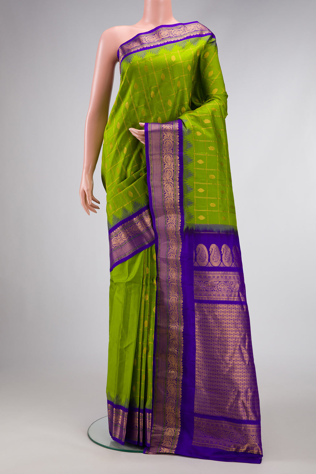 Parrot Green Dual Tone Gadwal Silk Saree with Checked design on the body and Temple Border.  displayed on a mannequin