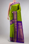 Parrot Green Dual Tone Gadwal Silk Saree with Checked design on the body and Temple Border.  displayed on a mannequin