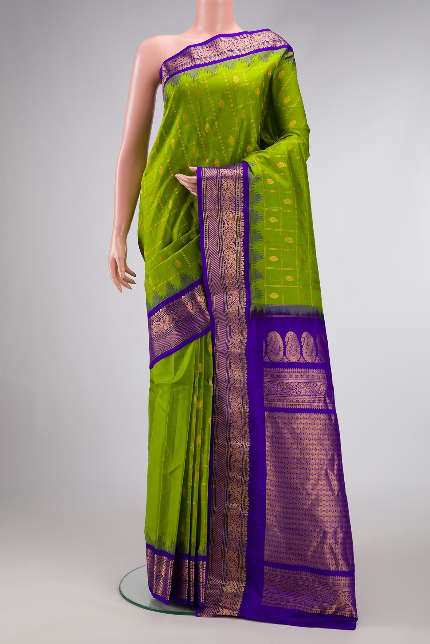 Parrot Green Dual Tone Gadwal Silk Saree with Checked design on the body and Temple Border.  displayed on a mannequin
