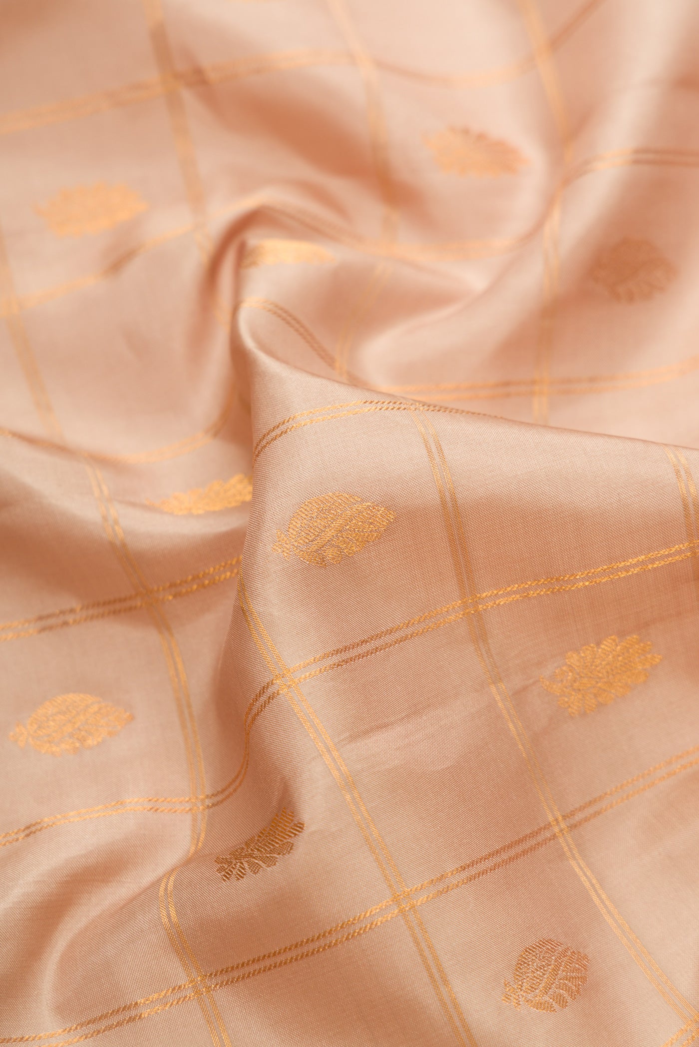 Close up of Beige Dual Tone Gadwal Silk Saree with Checked design on the body and Temple Border.  displaying folds