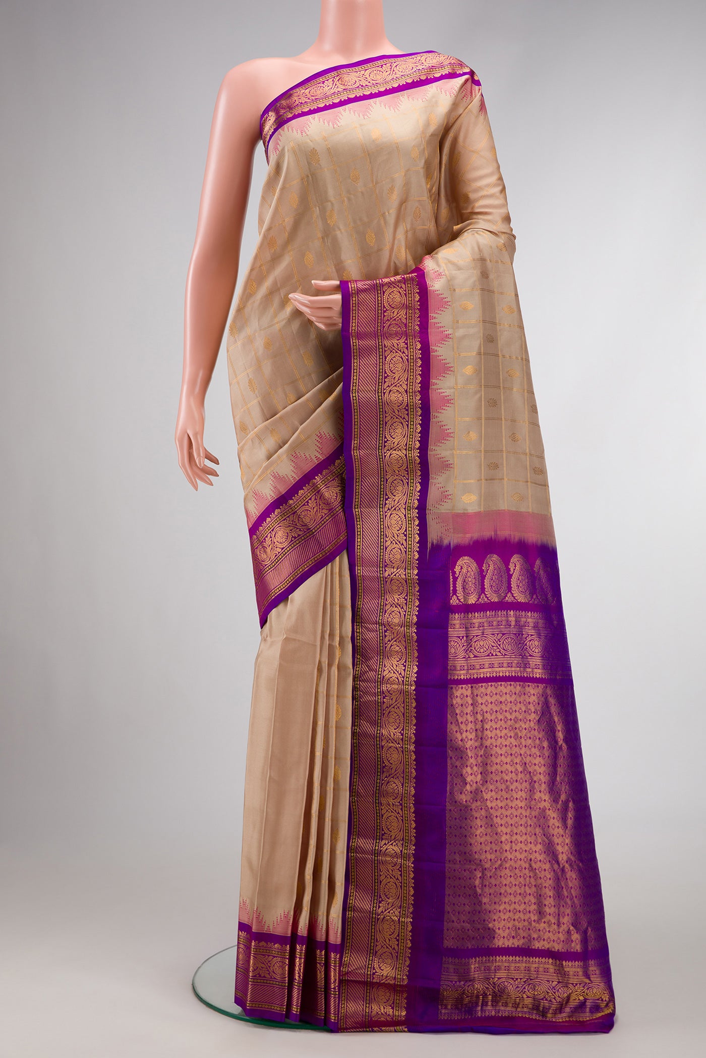 Beige Dual Tone Gadwal Silk Saree with Checked design on the body and Temple Border.  displayed on a mannequin