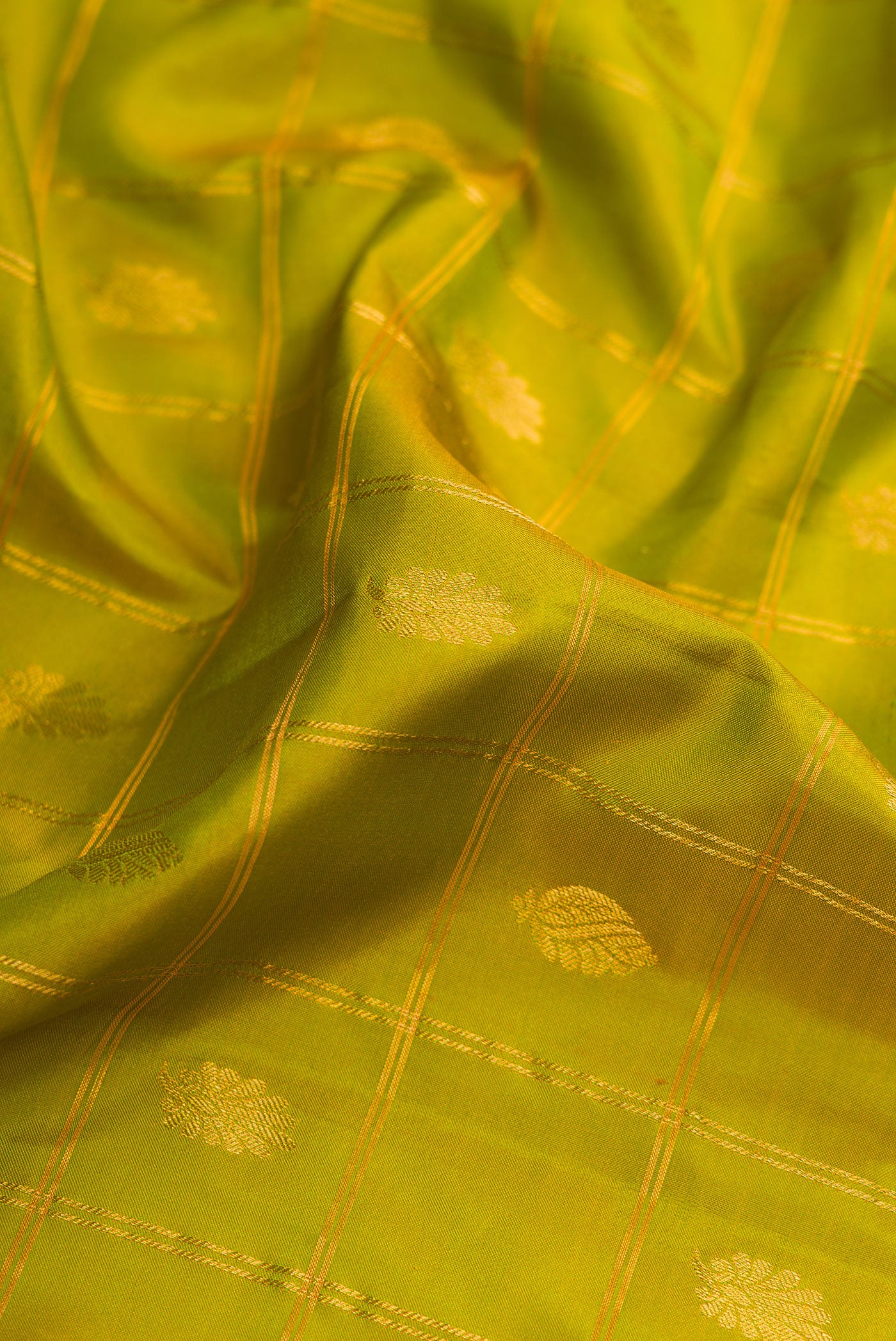 Close up of Parrot Green Dual Tone Gadwal Silk Saree with Checked design on the body and Zari Border.  displaying folds