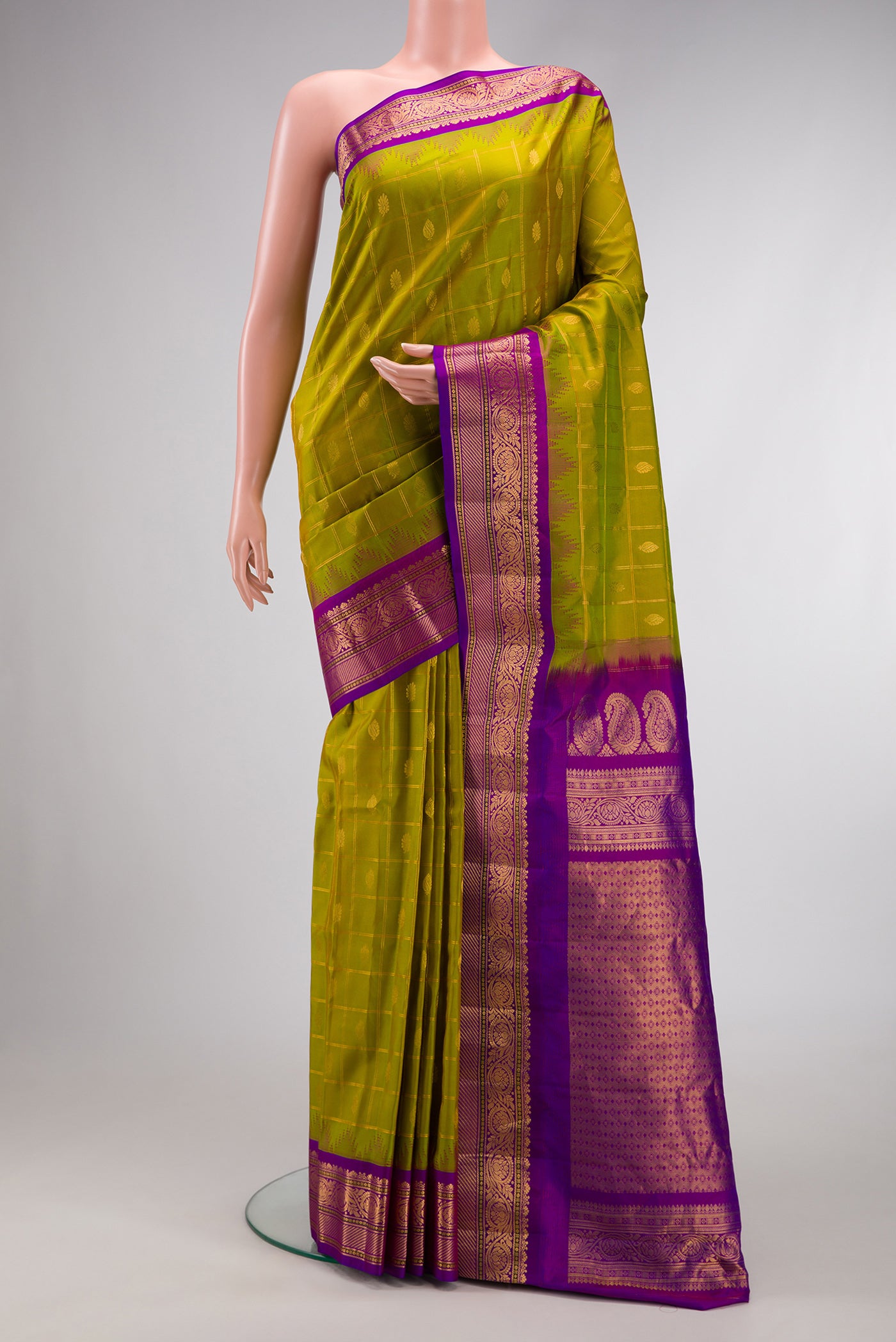 Parrot Green Dual Tone Gadwal Silk Saree with Checked design on the body and Zari Border.  displayed on a mannequin
