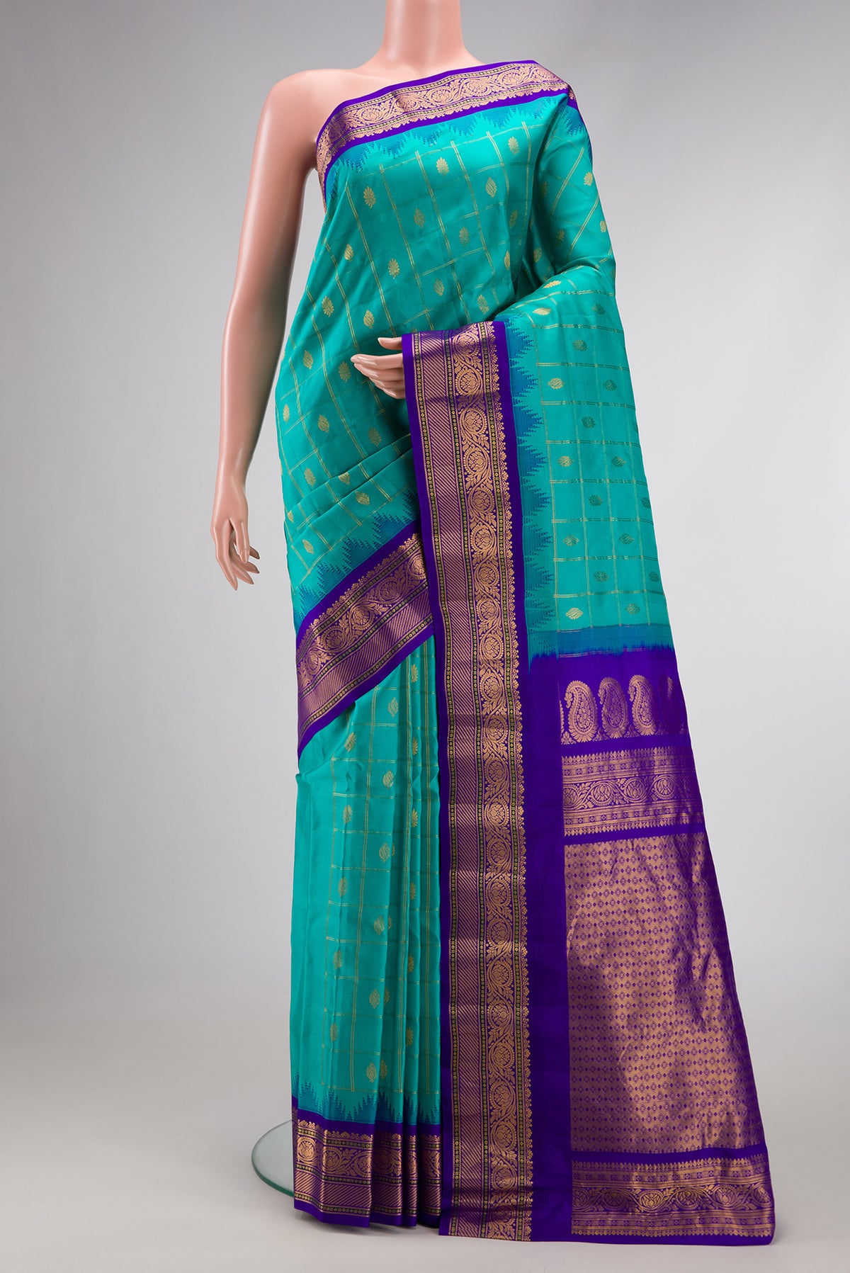 Green Dual Tone Gadwal Silk Saree with Zari Butta on the body and Zari Border.  displayed on a mannequin
