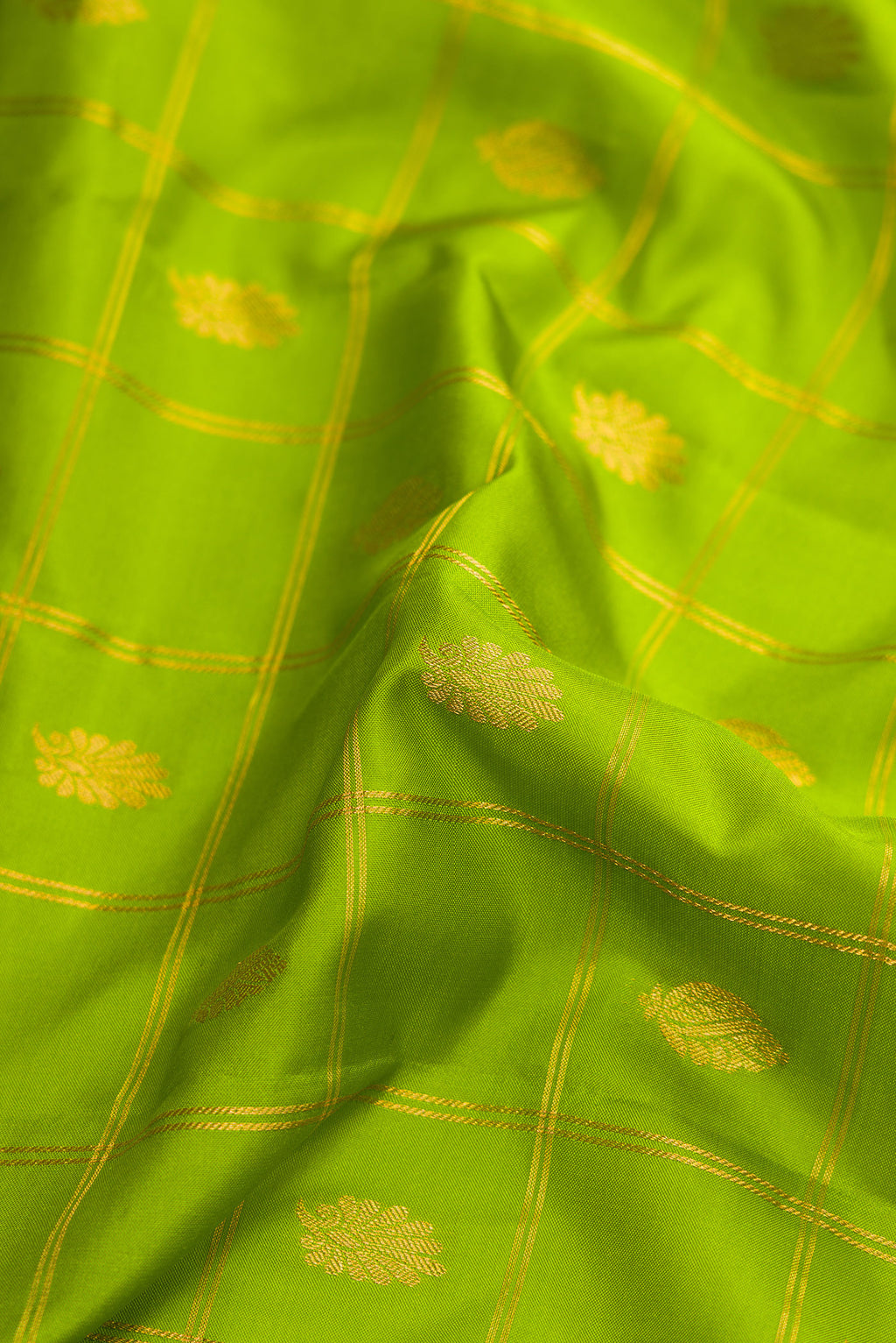 Close up of Parrot Green Dual Tone Gadwal Silk Saree with Checked design on the body and Zari Border.  displaying folds