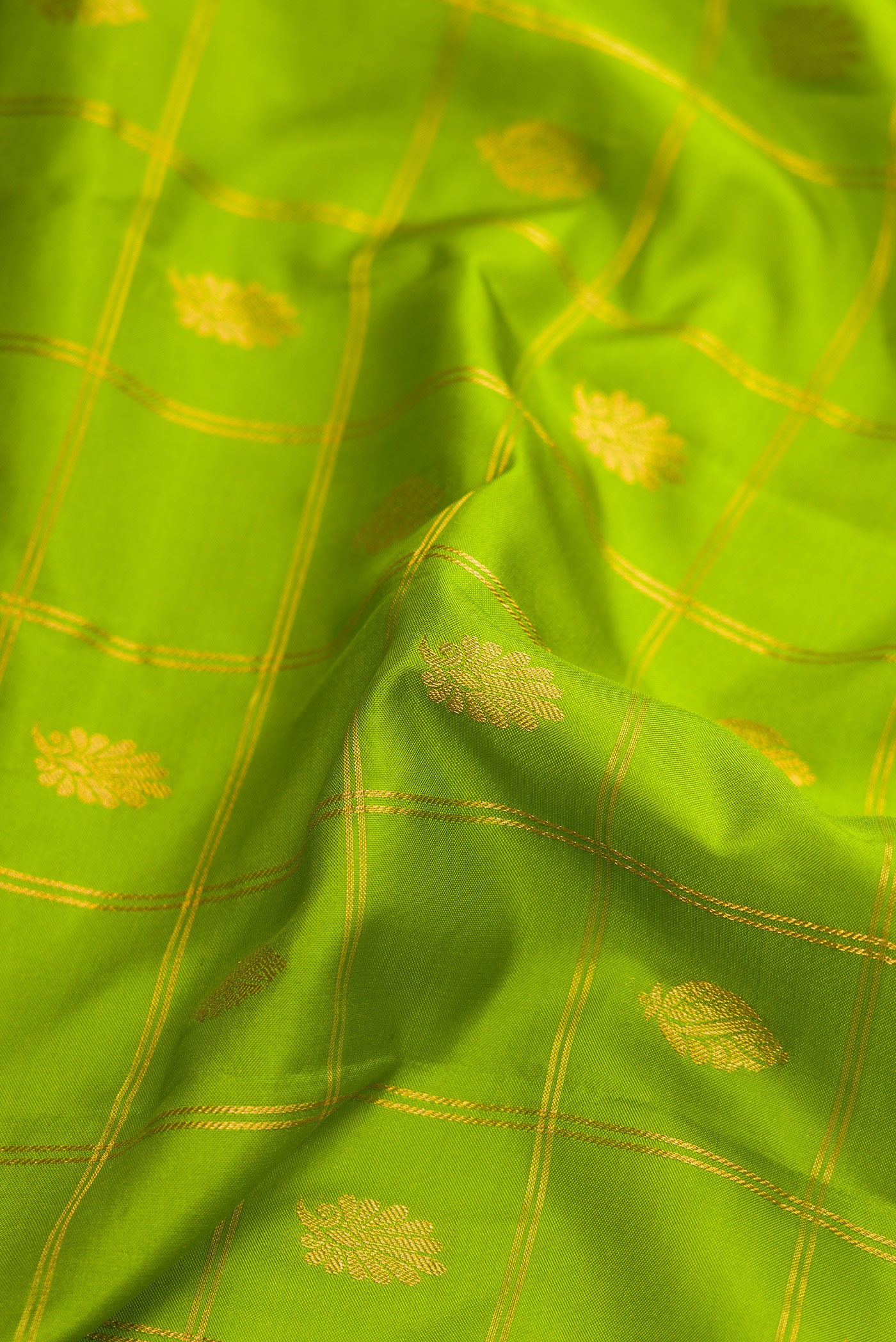 Close up of Parrot Green Dual Tone Gadwal Silk Saree with Checked design on the body and Zari Border.  displaying folds