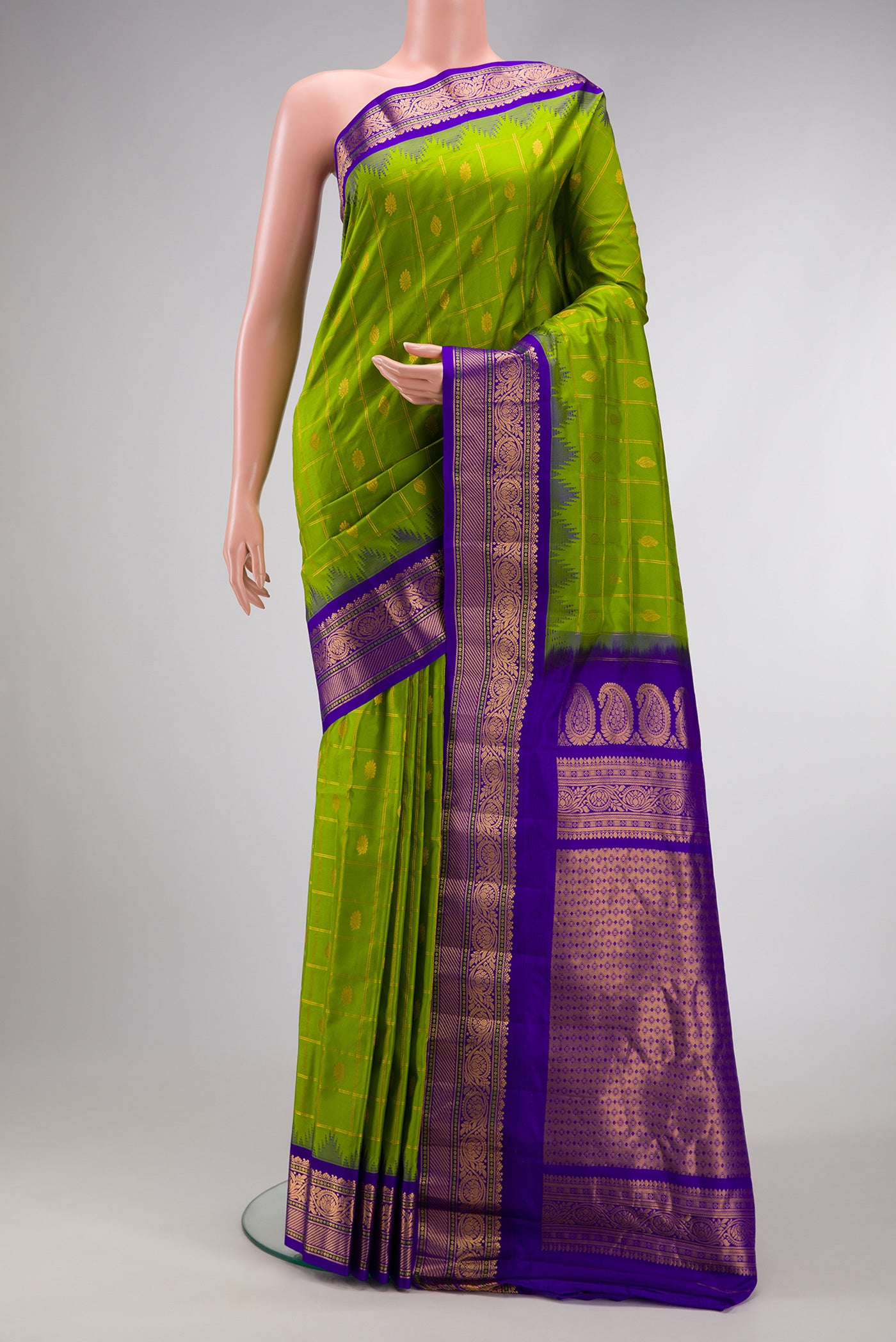 Parrot Green Dual Tone Gadwal Silk Saree with Checked design on the body and Zari Border.  displayed on a mannequin