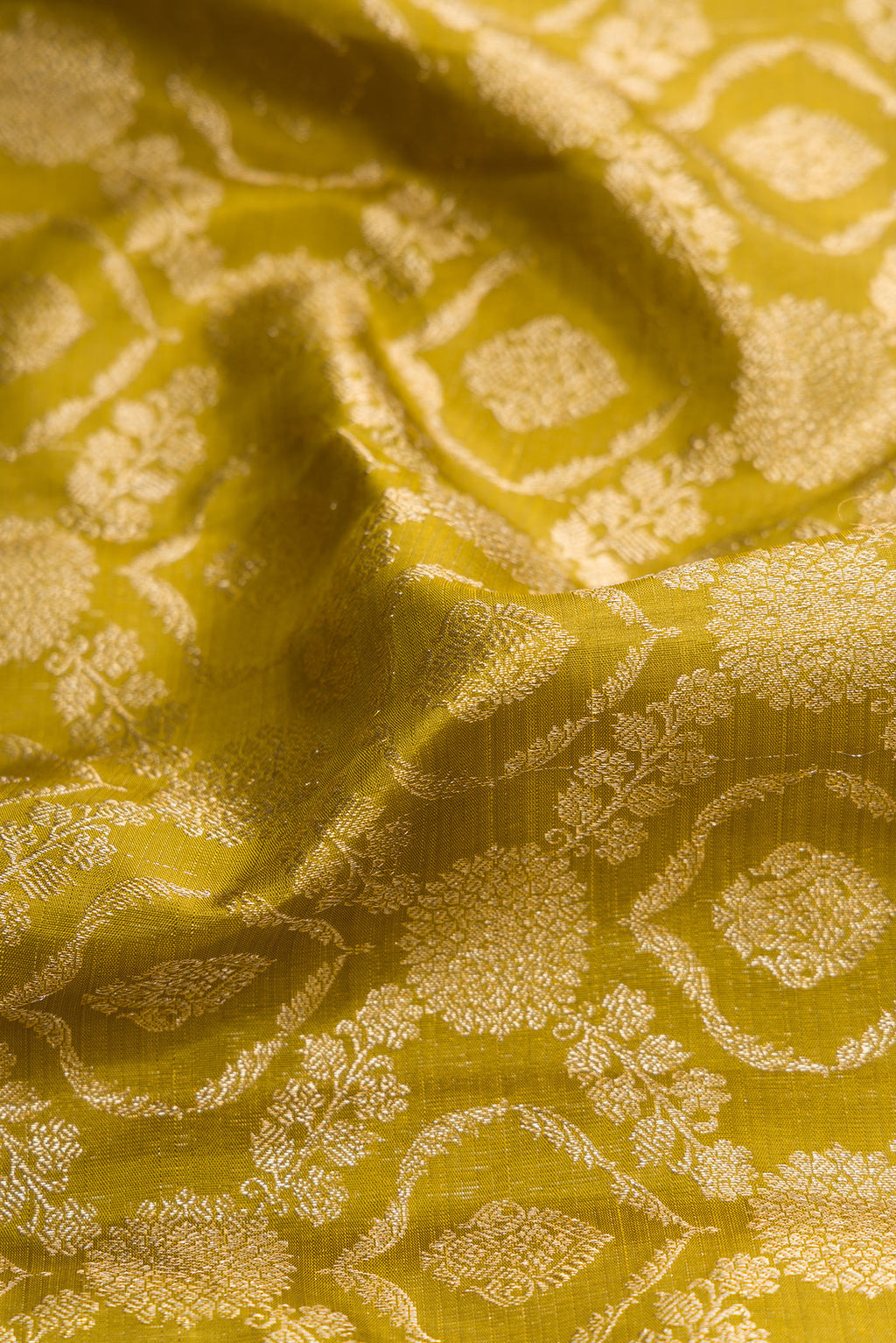 Close up of Mehandi Green Dual Tone Kanchipuram Silk Saree with Zari Brocade on the body and Zari Border.  displaying folds