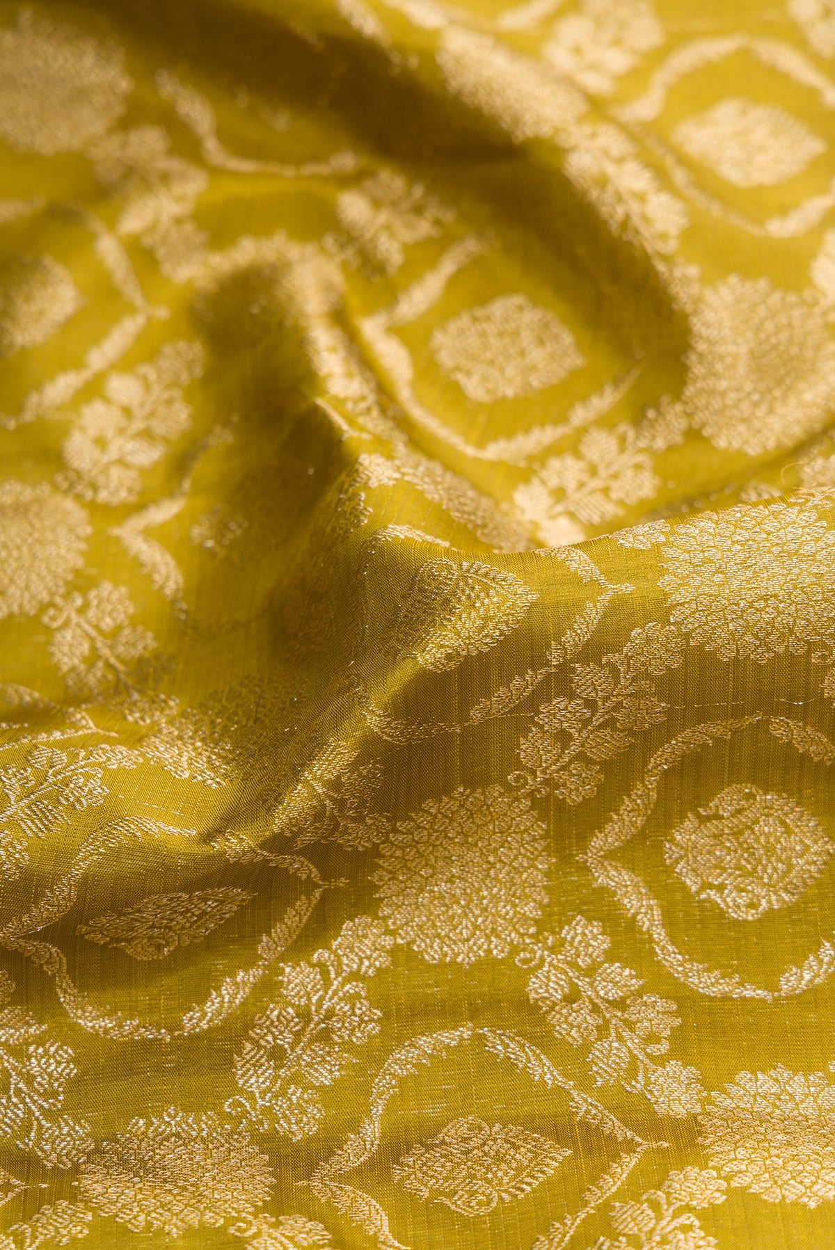 Close up of Mehandi Green Dual Tone Kanchipuram Silk Saree with Zari Brocade on the body and Zari Border.  displaying folds