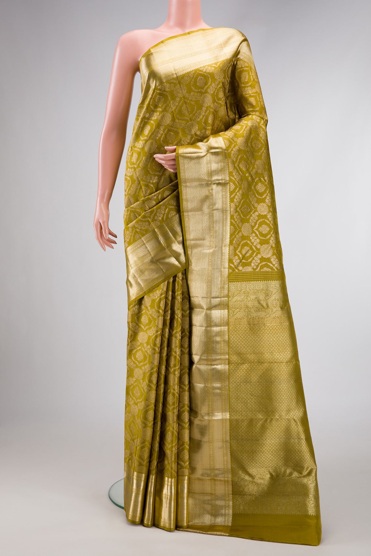 Mehandi Green Dual Tone Kanchipuram Silk Saree with Zari Brocade on the body and Zari Border.  displayed on a mannequin