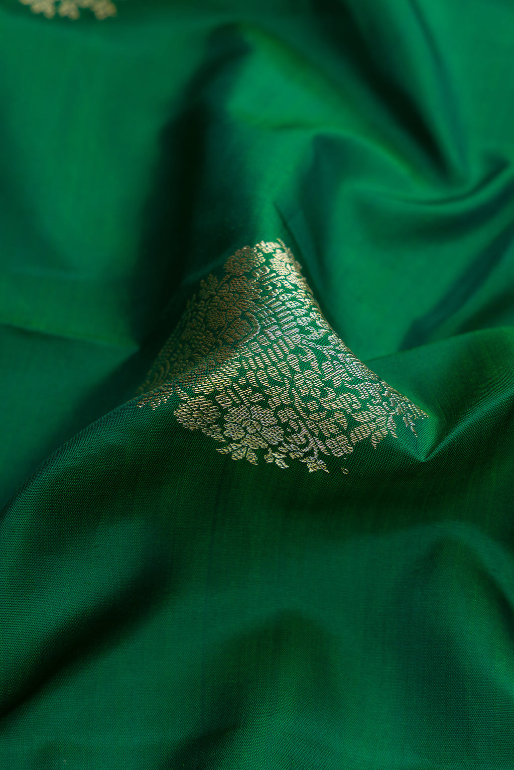 Close up of Bottle Green Dual Tone Kanjivaram Silk Saree with Zari Butta on the body and Zari Border.  displaying folds