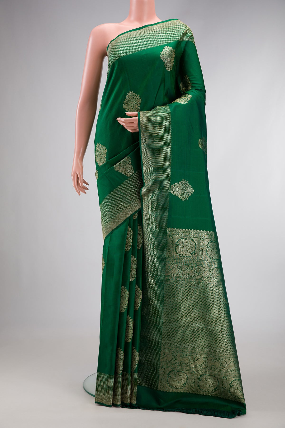 Bottle Green Dual Tone Kanjivaram Silk Saree with Zari Butta on the body and Zari Border.  displayed on a mannequin