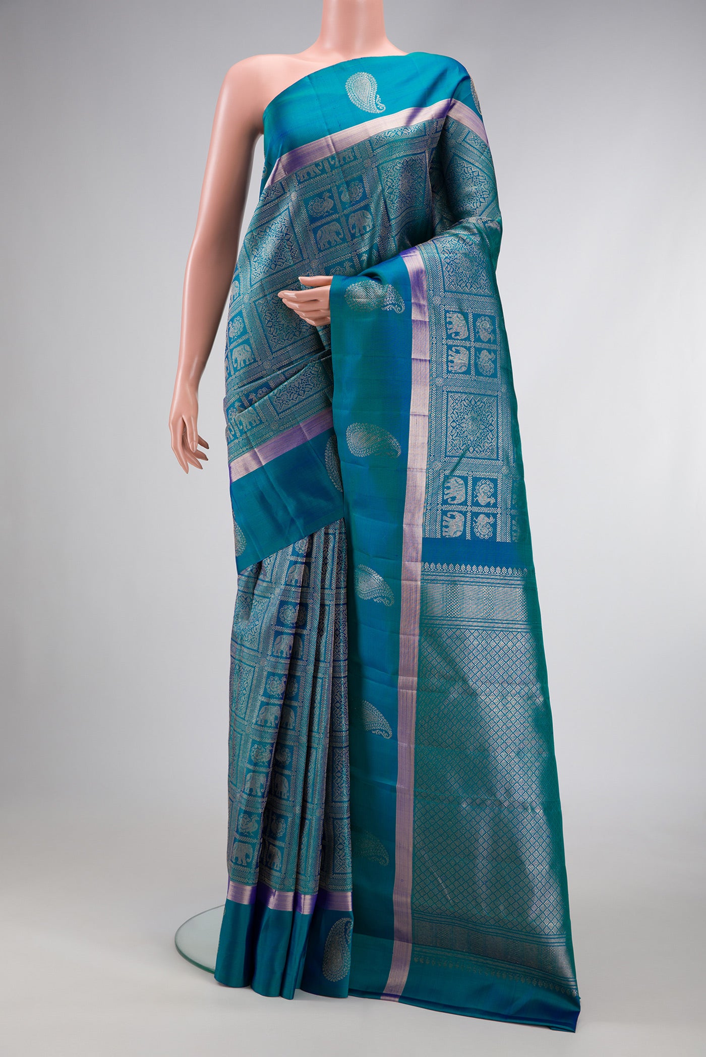 Peacock Blue Dual Tone Kanchipuram Silk Saree with Zari Brocade on the body and Zari Border.  displayed on a mannequin