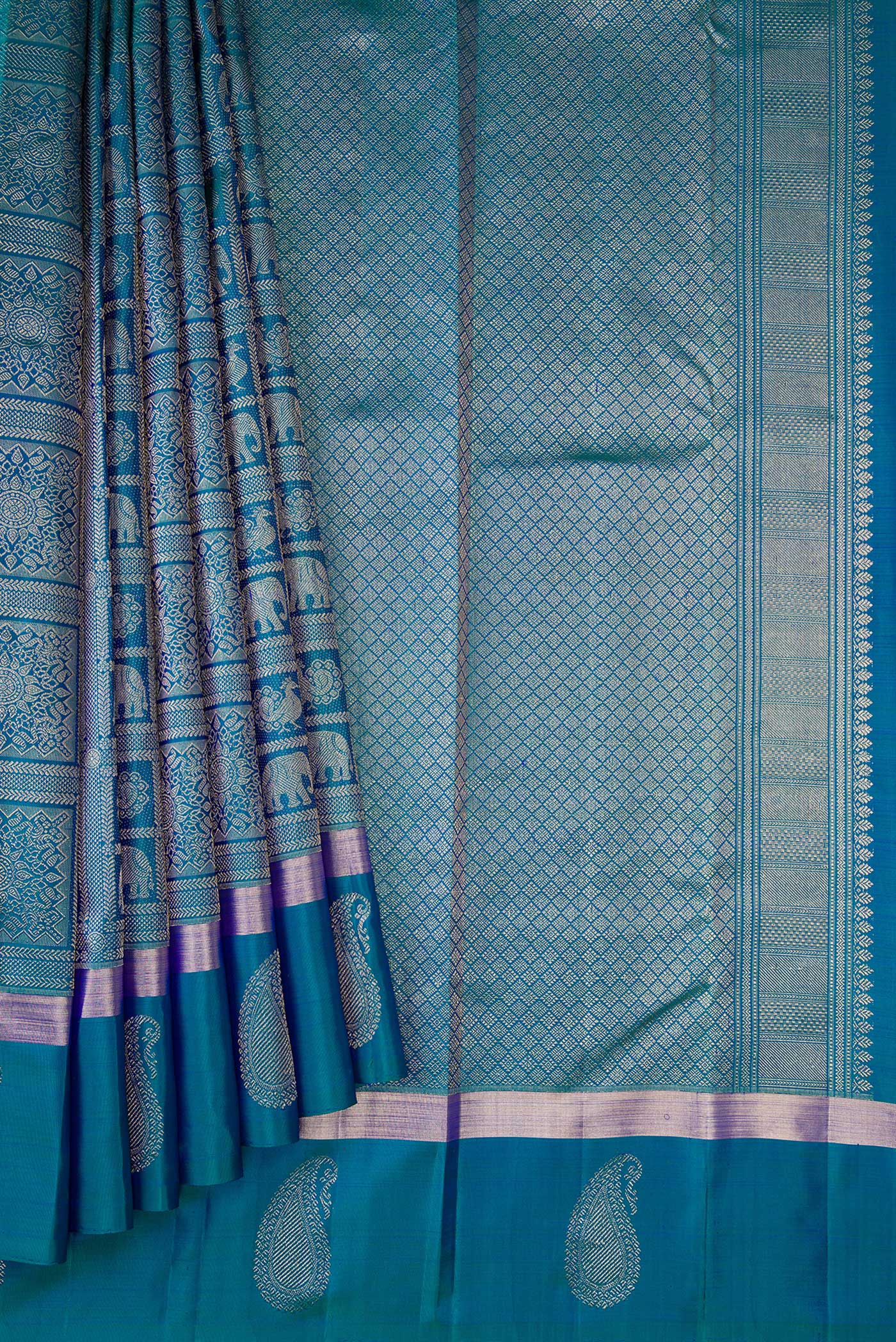Pleats and pallu of Peacock Blue Dual Tone Kanchipuram Silk Saree with Zari Brocade on the body and Zari Border. 