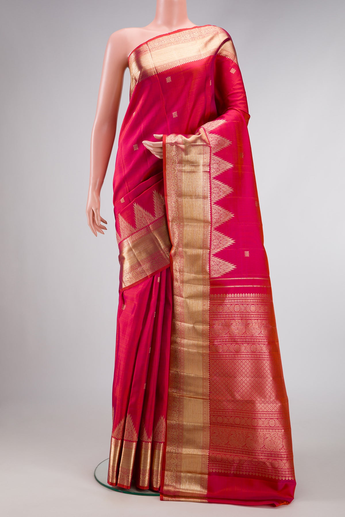Coral Dual Tone Kanjivaram Silk Saree with Zari Butta on the body and Fancy Border.  displayed on a mannequin