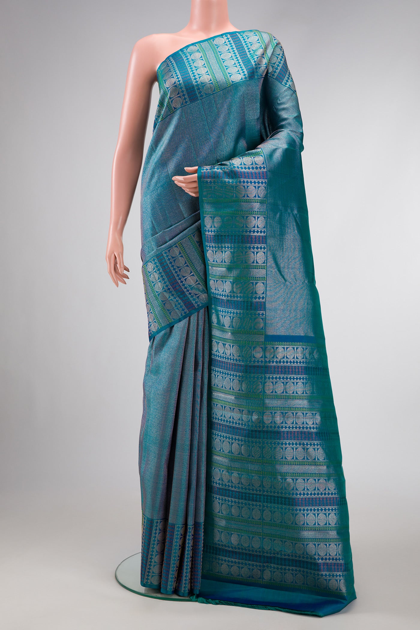 Peacock Blue Dual Tone Kanchipuram Silk Saree with Zari Brocade on the body and Fancy Border.  displayed on a mannequin