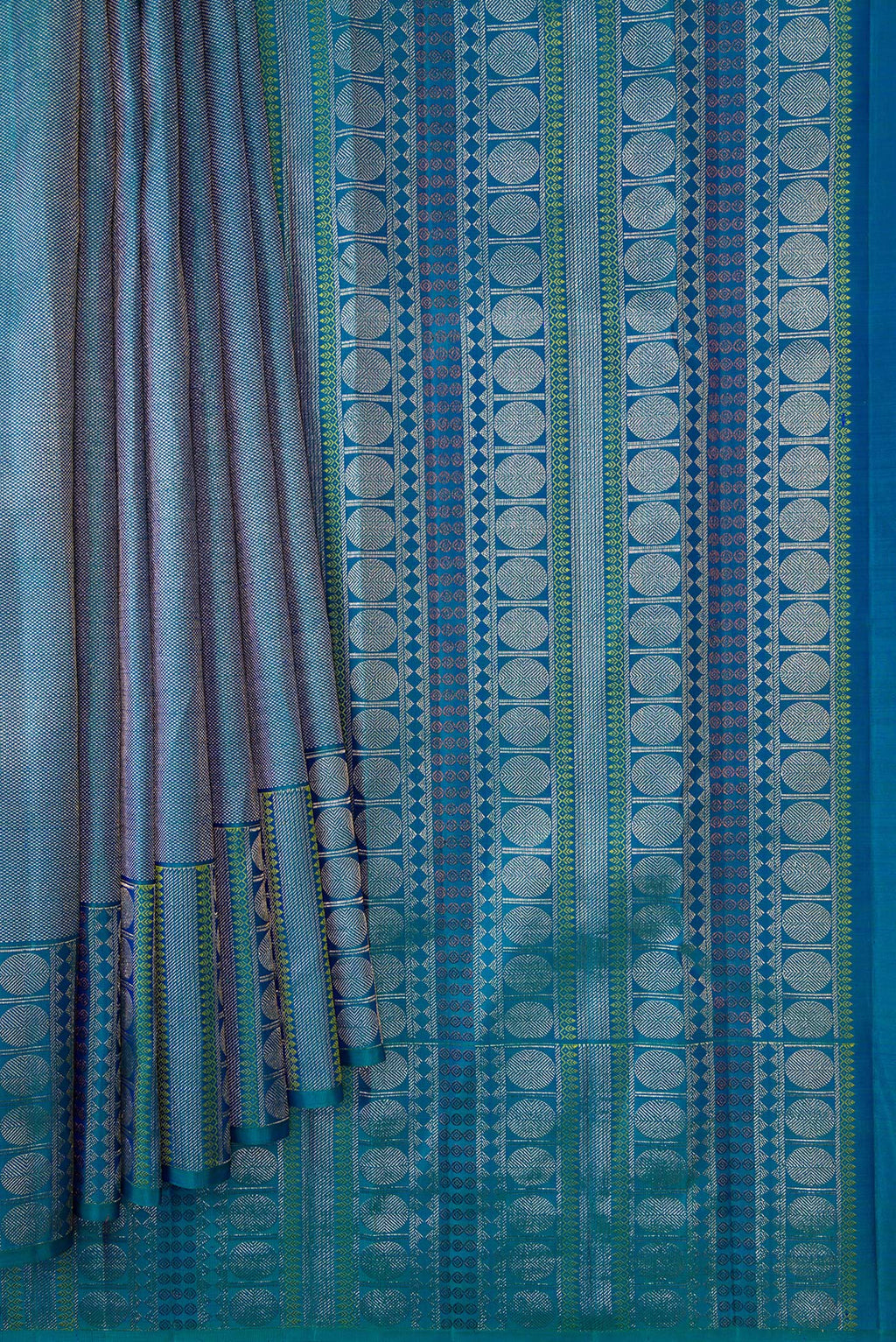 Pleats and pallu of Peacock Blue Dual Tone Kanchipuram Silk Saree with Zari Brocade on the body and Fancy Border. 