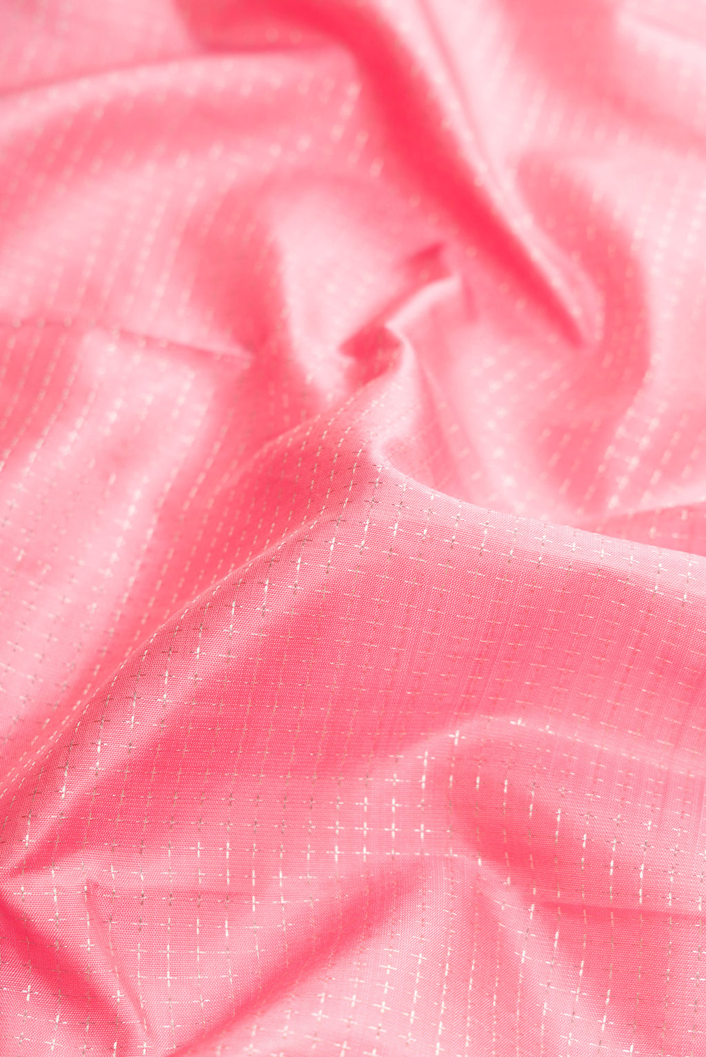 Close up of Pink Dual Tone Kanjivaram Silk Saree with Zari Butta on the body and Zari Border.  displaying folds