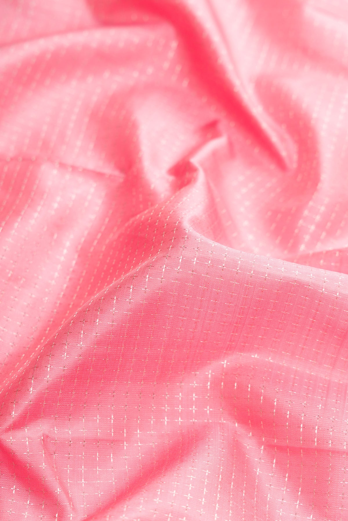 Close up of Pink Dual Tone Kanjivaram Silk Saree with Zari Butta on the body and Zari Border.  displaying folds