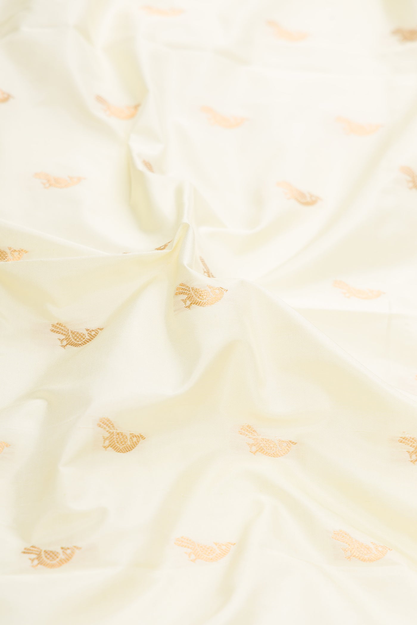 Close up of Off White Dual Tone Paithani Silk Saree with Zari Butta on the body and Paithani Border.  displaying folds