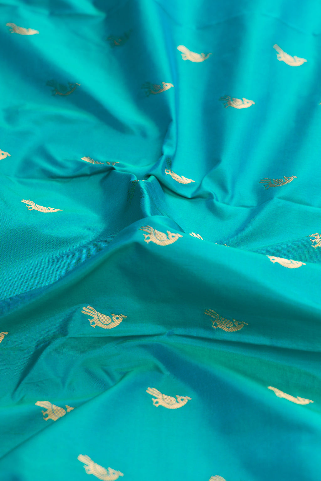 Close up of Green Dual Tone Paithani Silk Saree with Zari Butta on the body and Paithani Border.  displaying folds