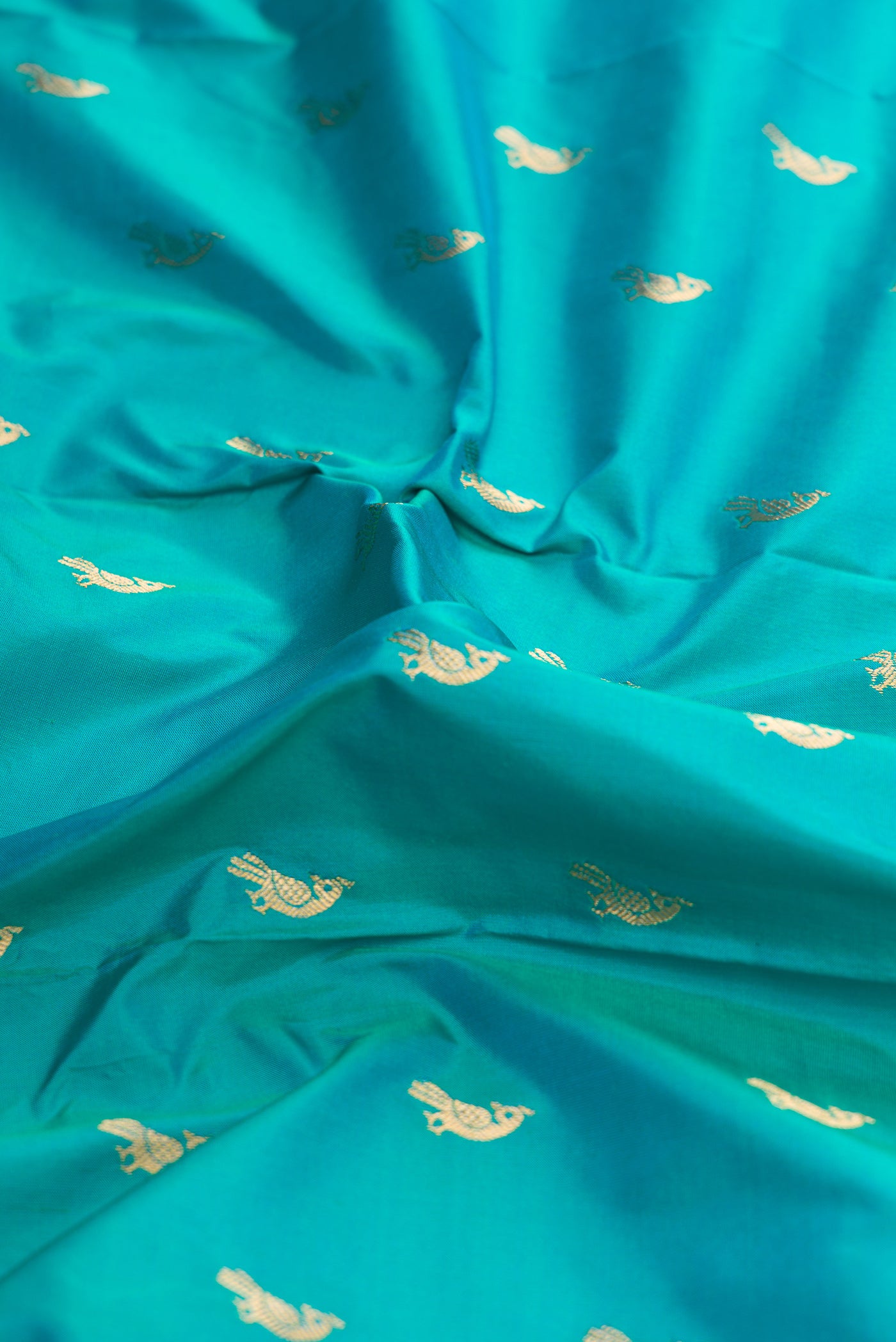 Close up of Green Dual Tone Paithani Silk Saree with Zari Butta on the body and Paithani Border.  displaying folds
