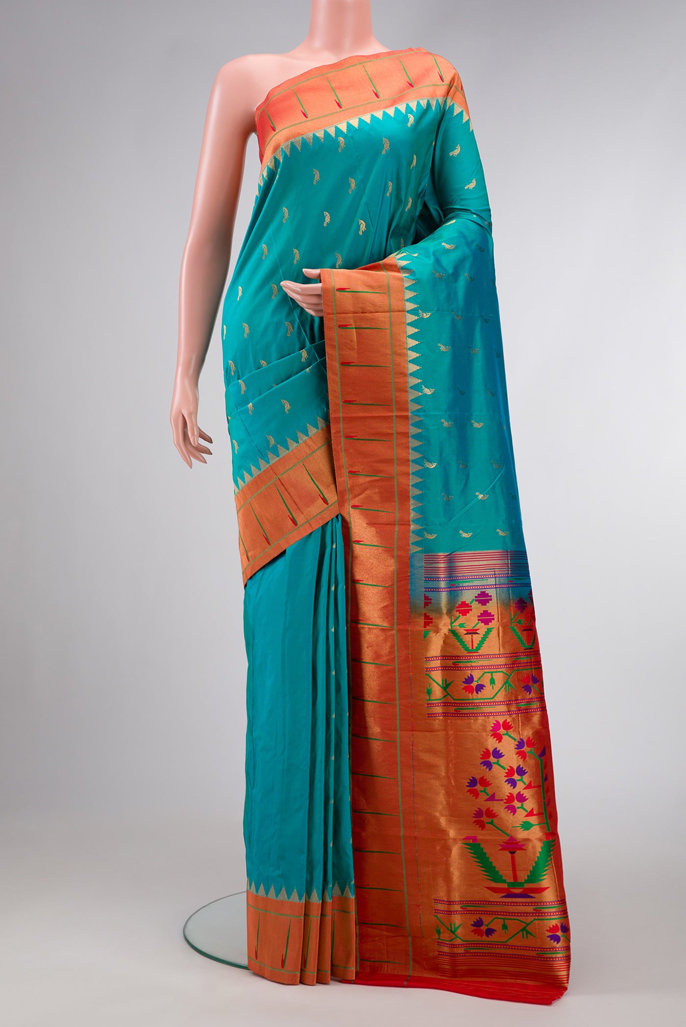 Green Dual Tone Paithani Silk Saree with Zari Butta on the body and Paithani Border.  displayed on a mannequin