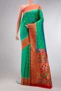 Green Dual Tone Paithani Silk Saree with Zari Butta on the body and Paithani Border.  displayed on a mannequin