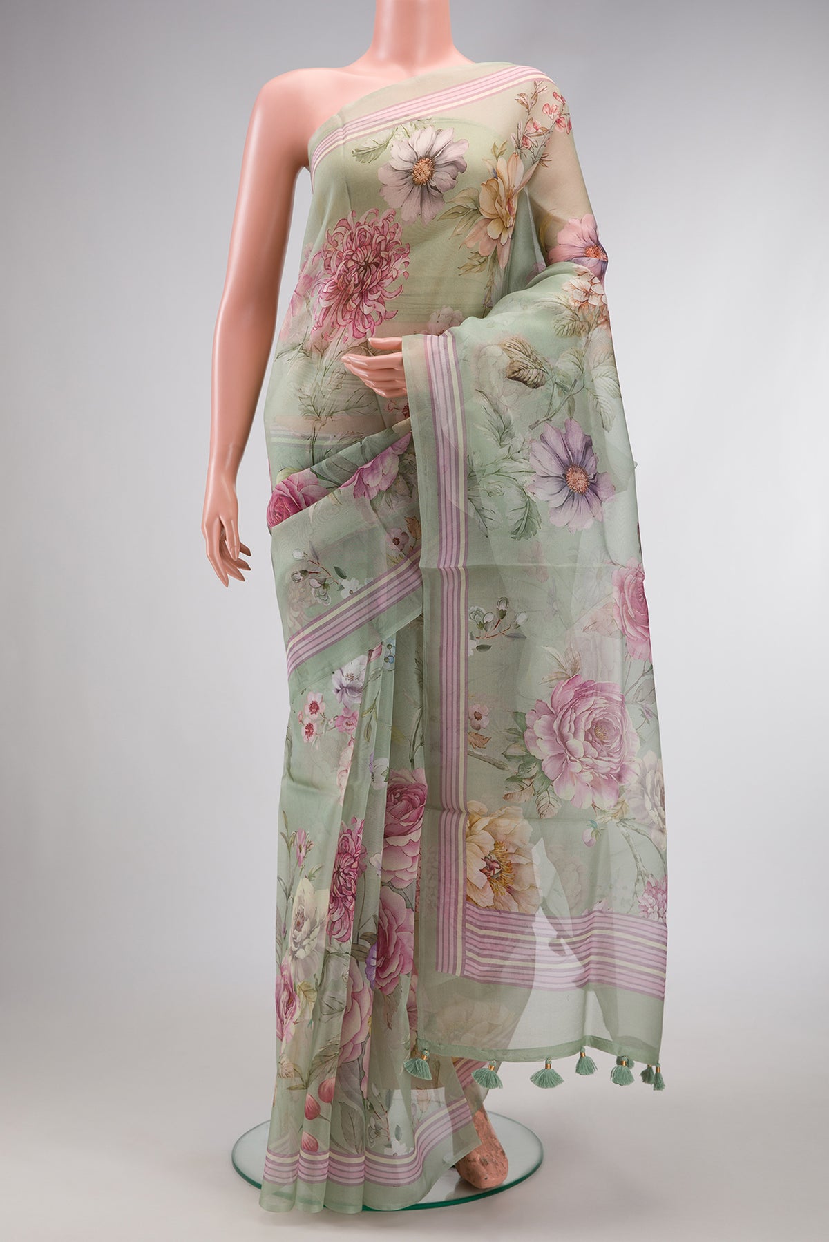 Pista Green Dual Tone Organza Silk Saree with Printed design on the body and Printed Border.  displayed on a mannequin