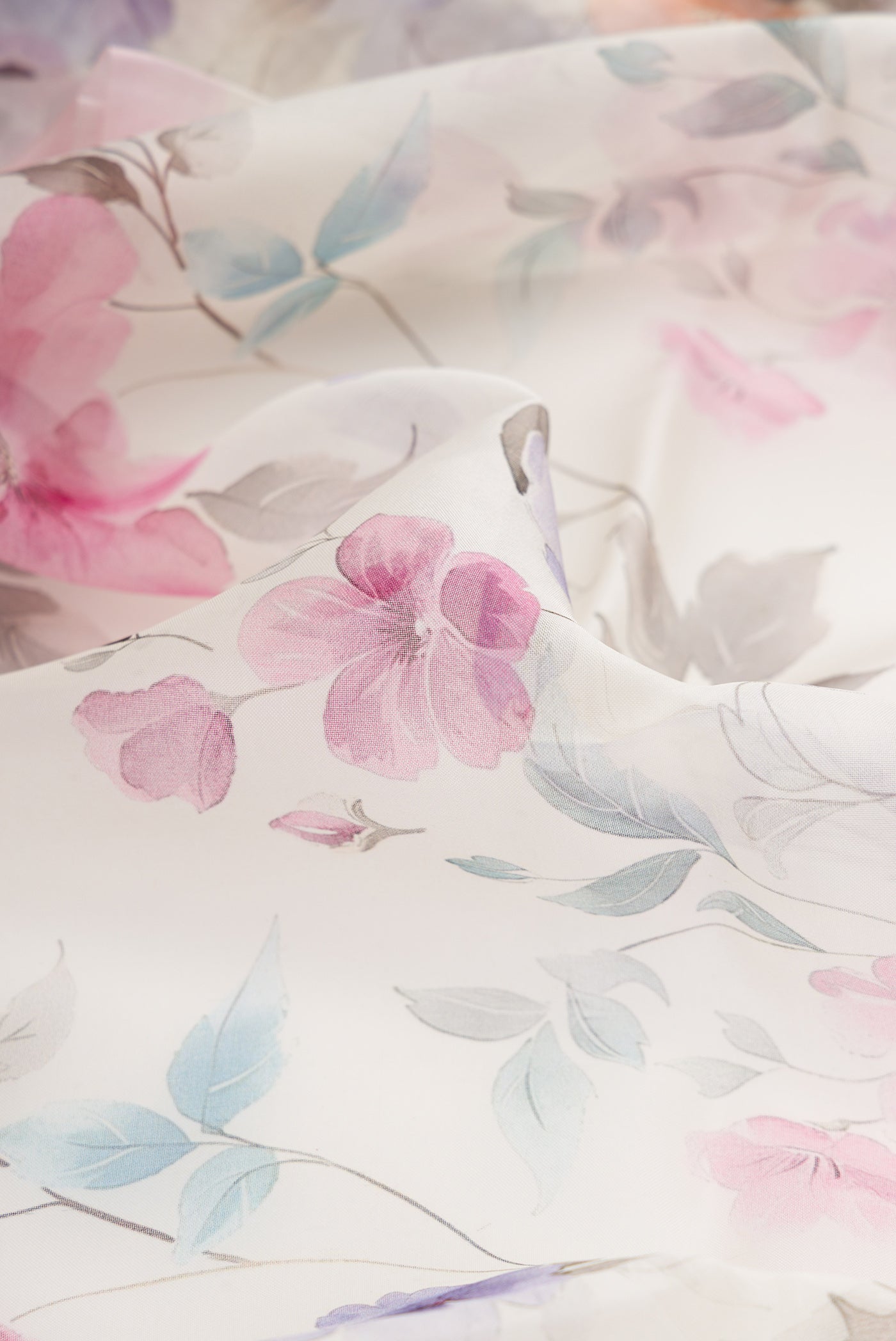 Close up of Off White Dual Tone Organza Silk Saree with Printed design on the body and Plain Border.  displaying folds