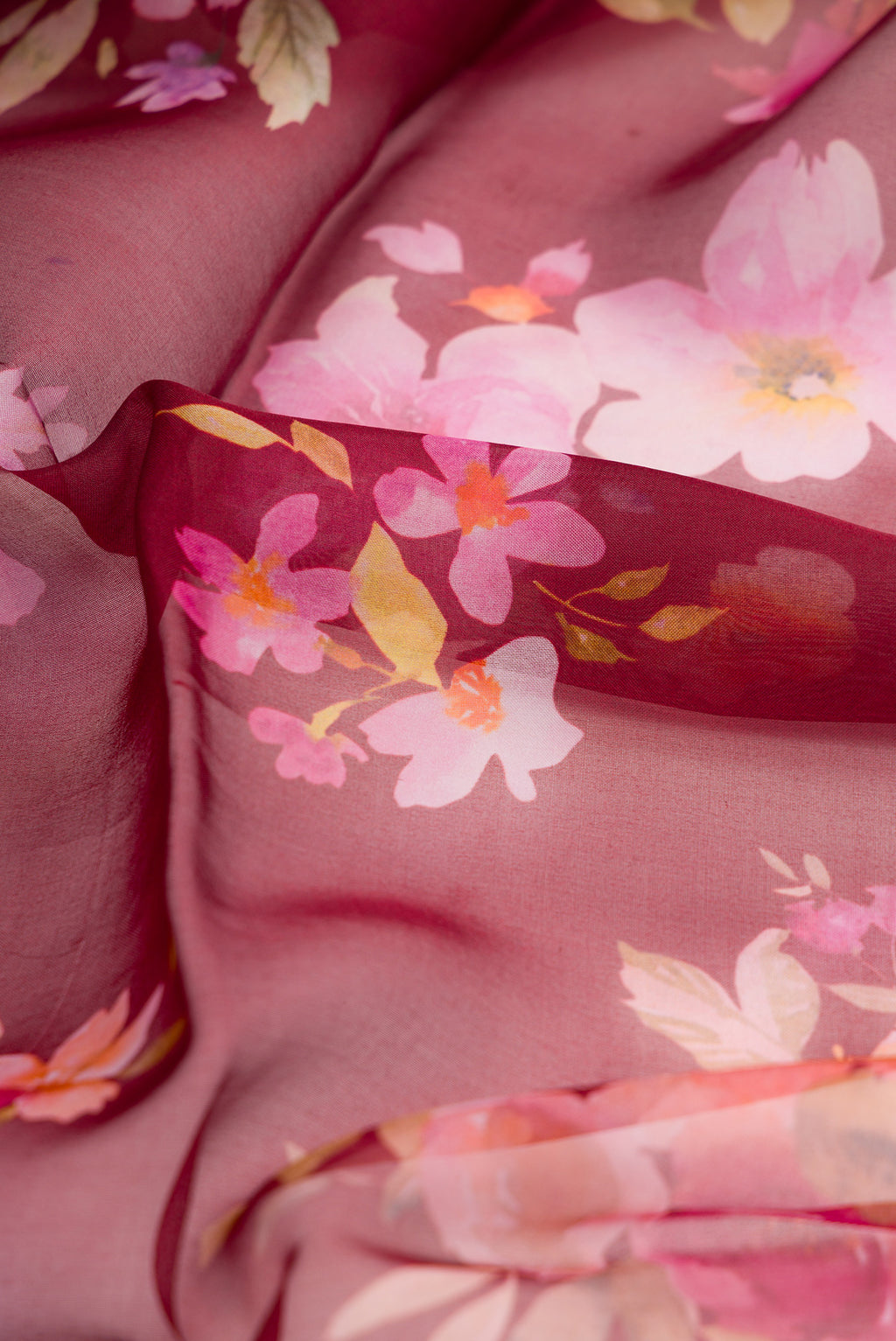 Close up of Maroon Dual Tone Organza Silk Saree with Printed design on the body and Without Border.  displaying folds