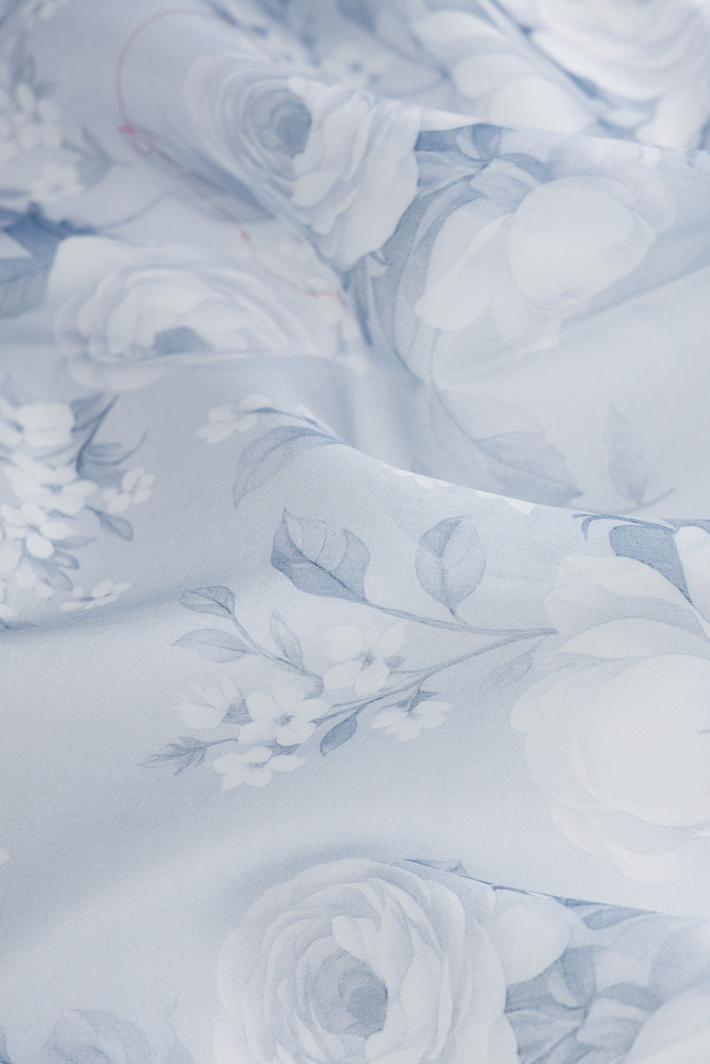 Close up of Grey Dual Tone Organza Silk Saree with Printed design on the body and Plain Border.  displaying folds