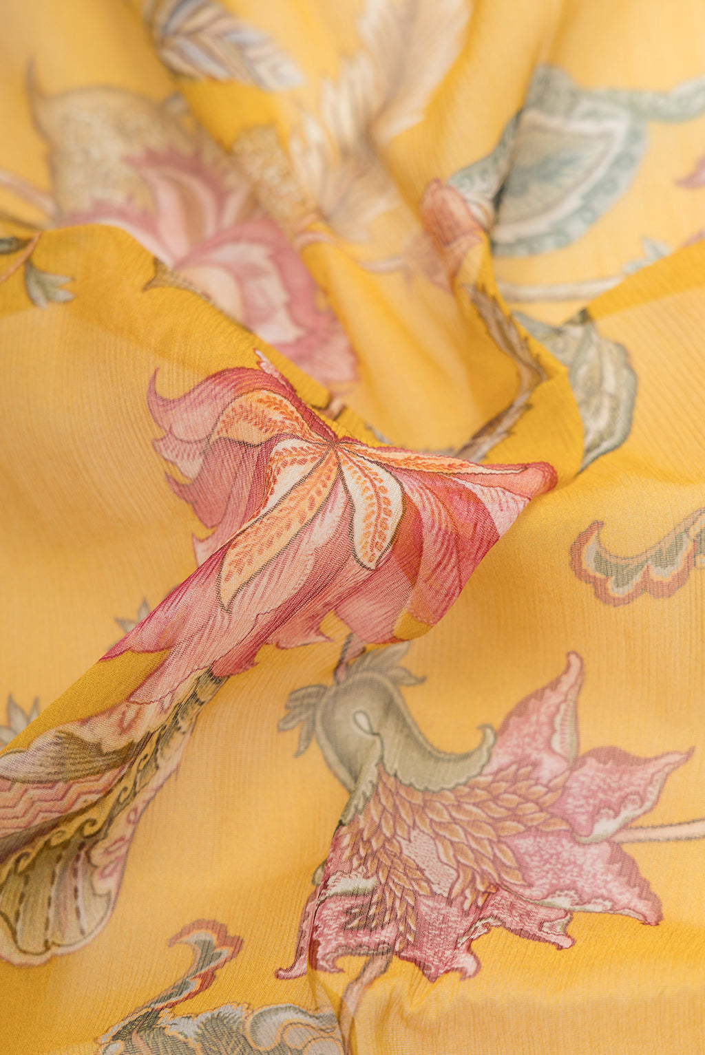Close up of Mustard Dual Tone Mysore Chiffon Saree with Printed design on the body and Without Border.  displaying folds