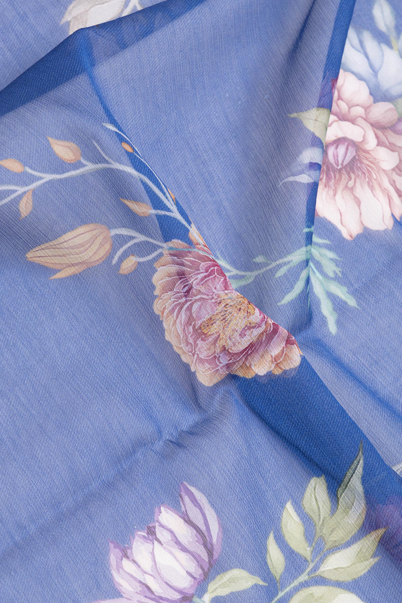 Close up of Royal Blue Mysore Chiffon Saree with Printed design on the body and Plain Border.  displaying folds