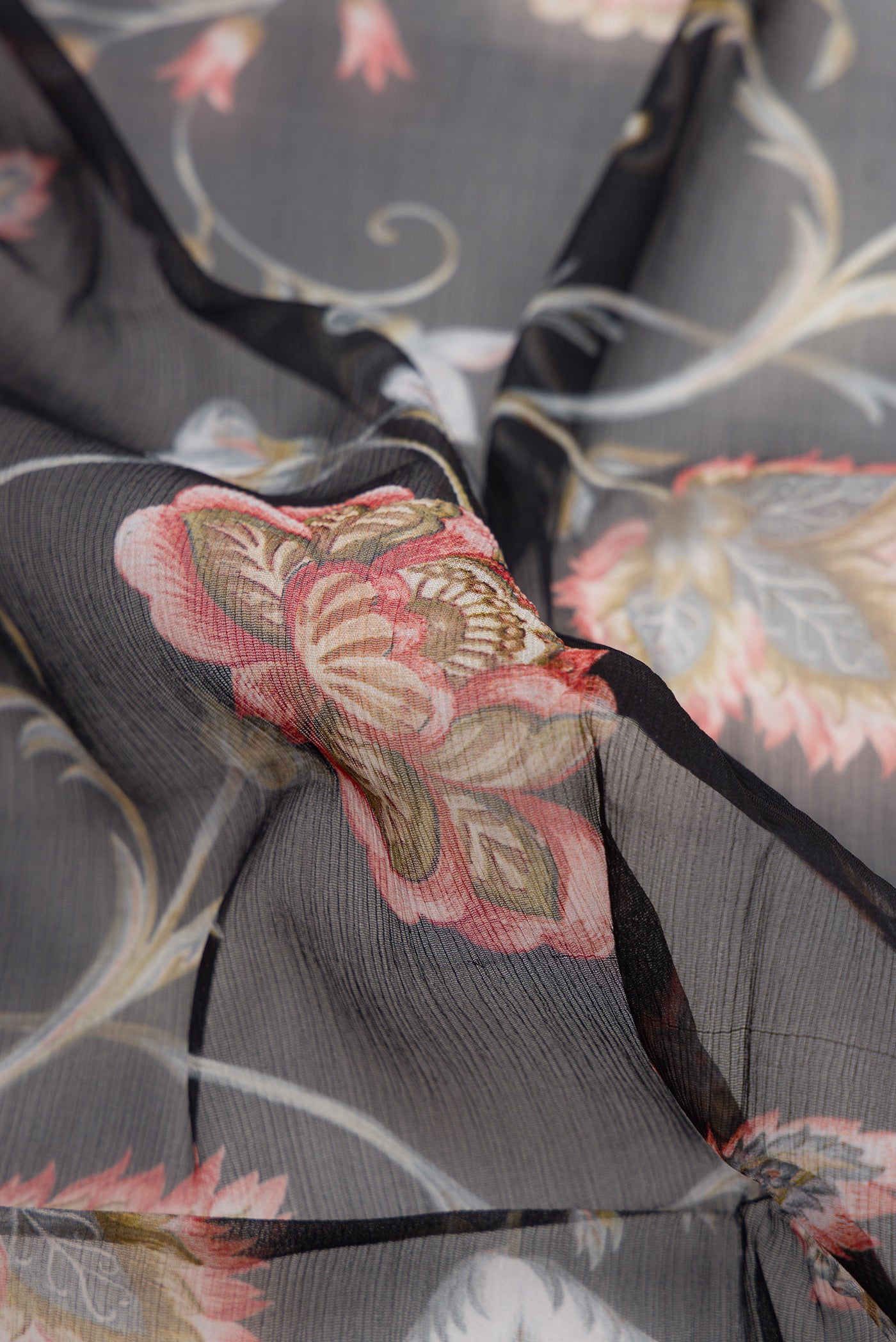 Close up of Black Dual Tone Mysore Chiffon Saree with Printed design on the body and Plain Border.  displaying folds