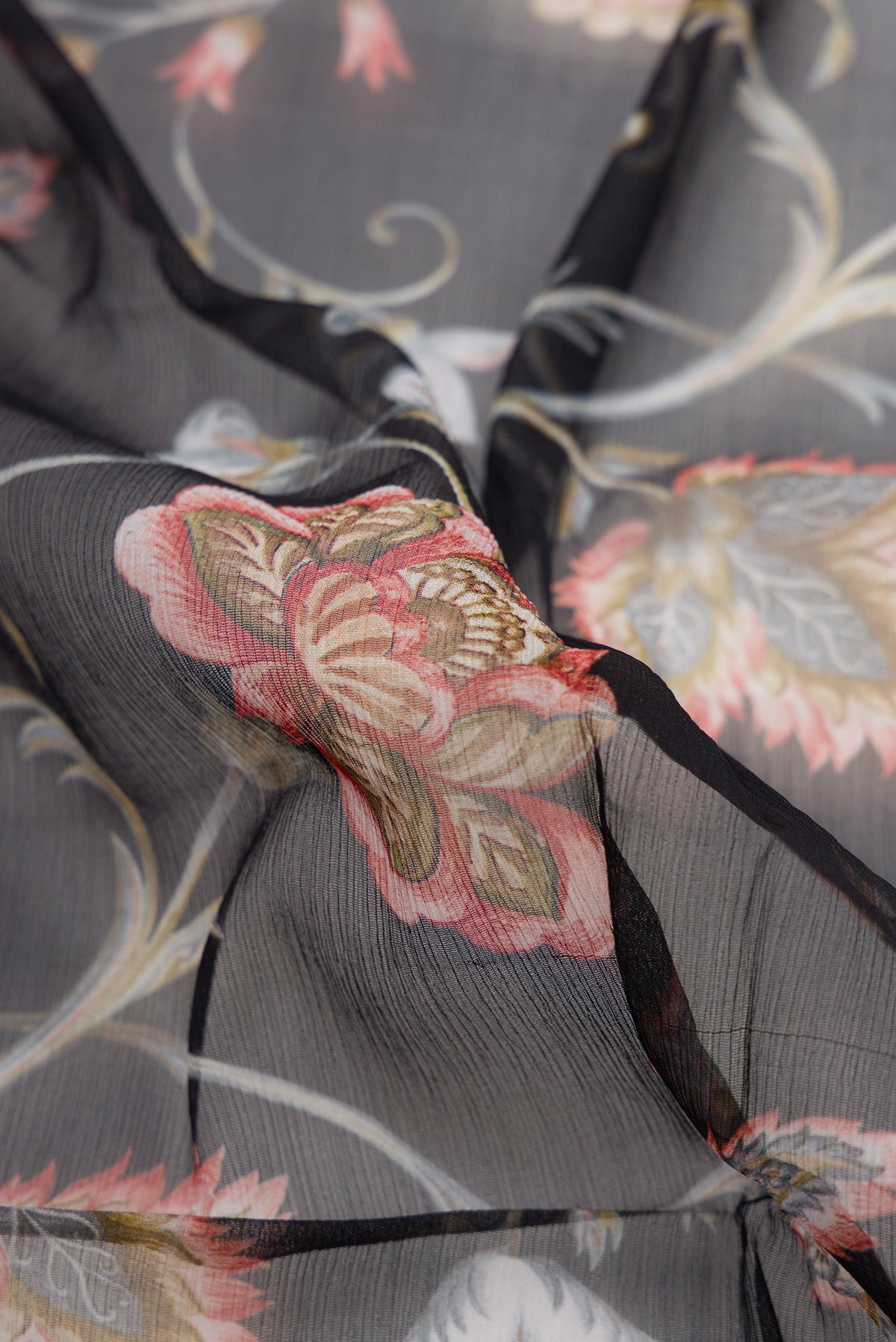 Close up of Black Dual Tone Mysore Chiffon Saree with Printed design on the body and Plain Border.  displaying folds