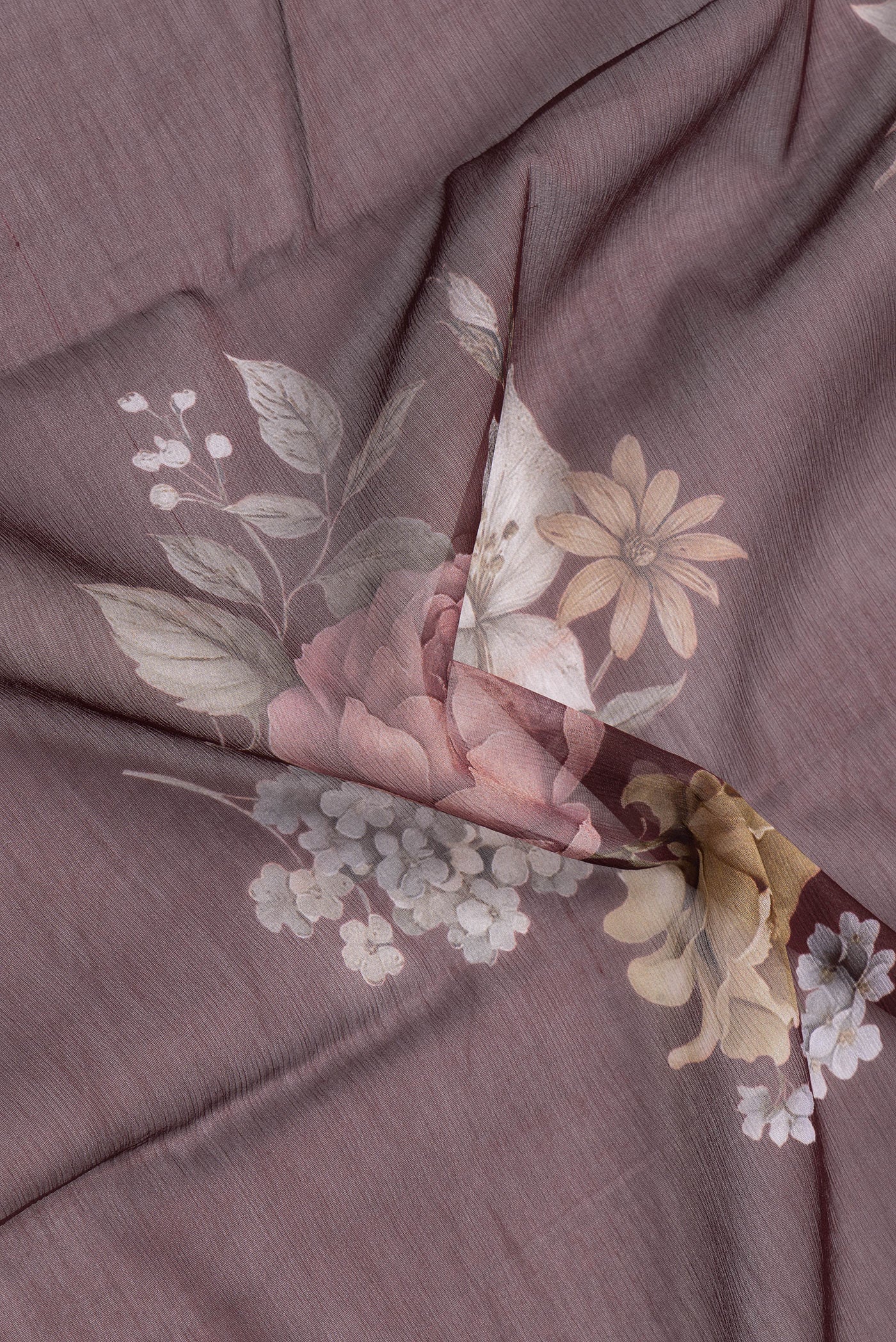 Close up of Coffee Brown Mysore Chiffon Saree with Printed design on the body and Printed Border.  displaying folds